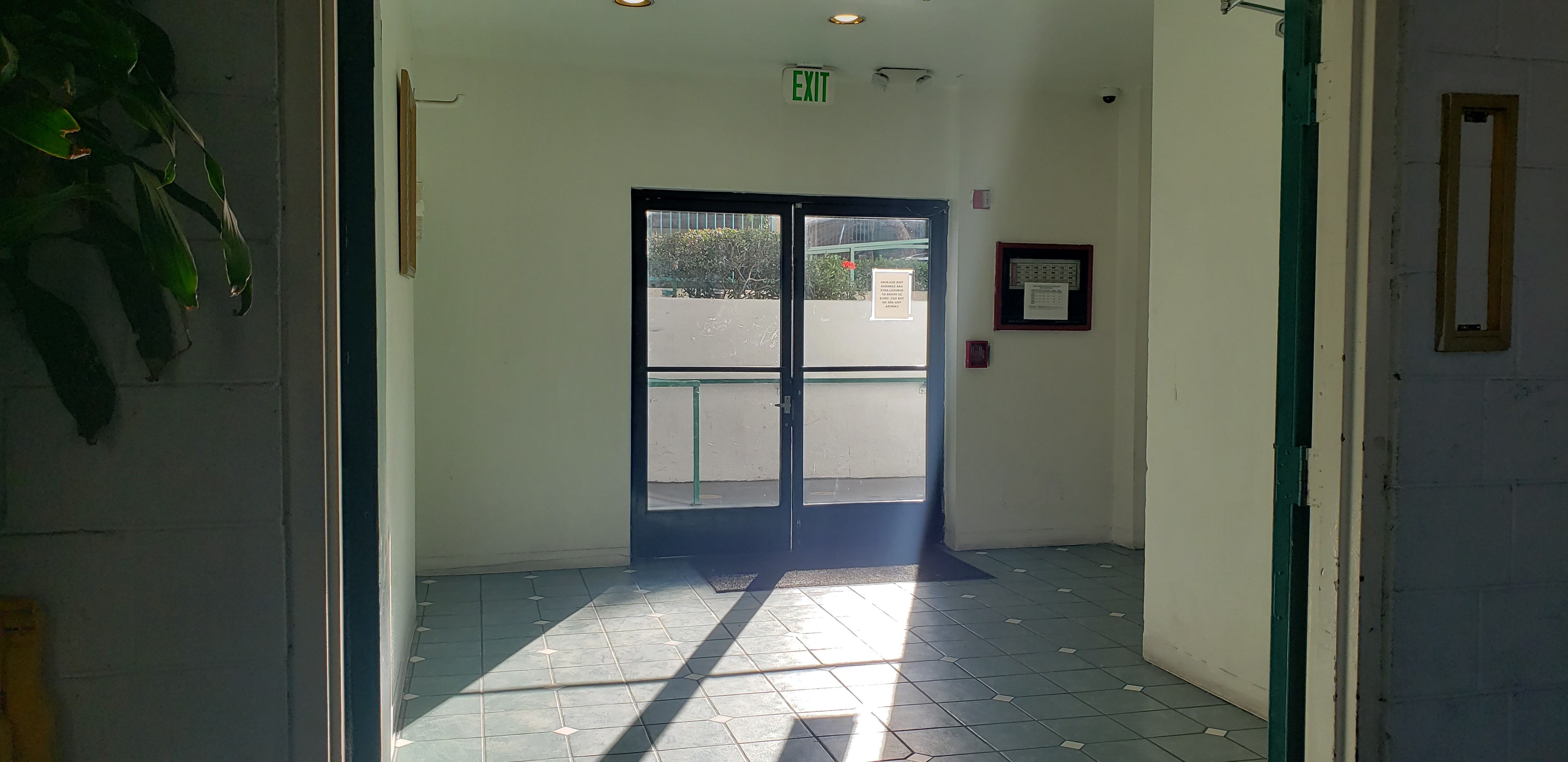 Interior view of Beverly City Lights Apartments showing exit with double glasss doors