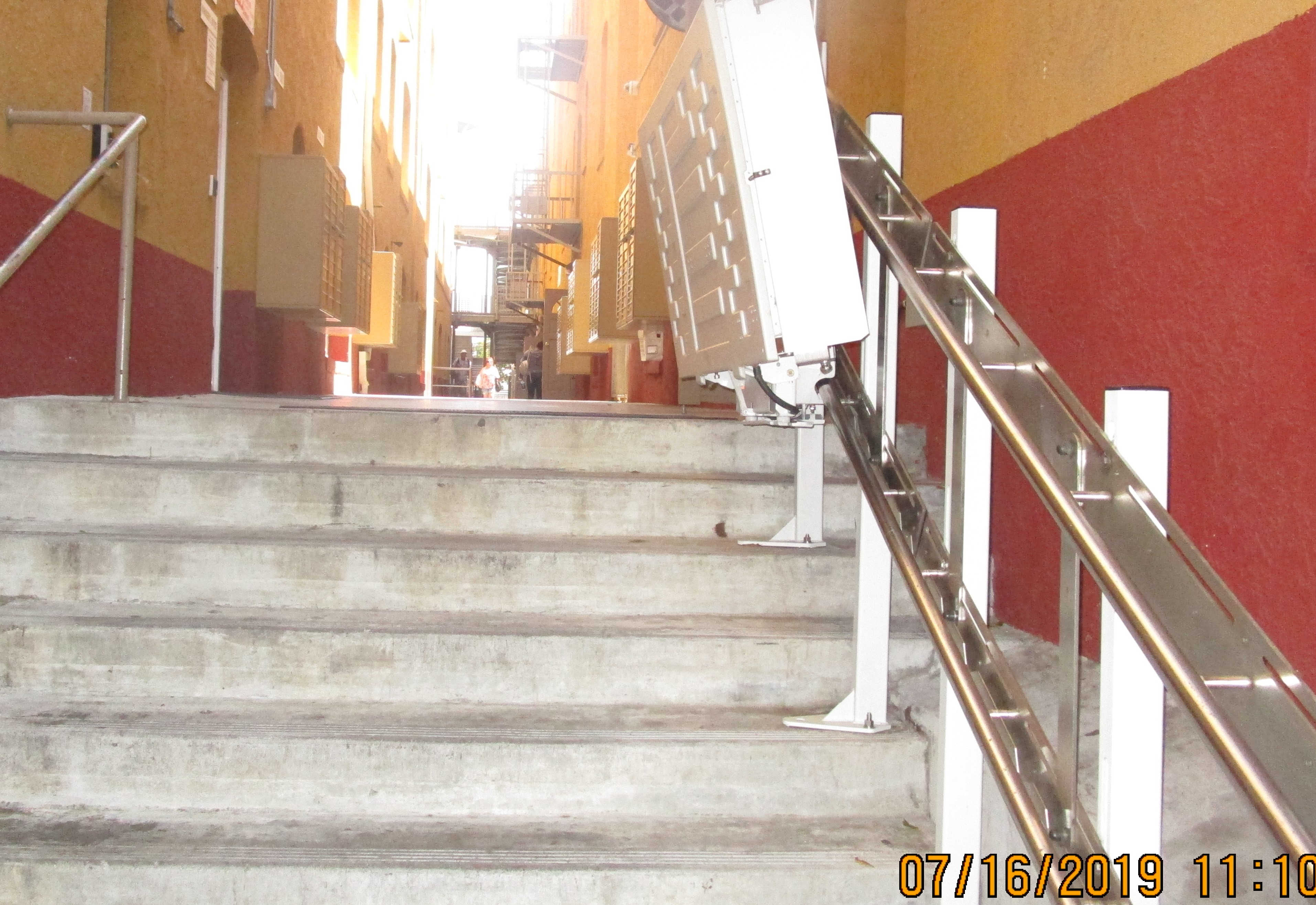 View of concrete steps with handrails.