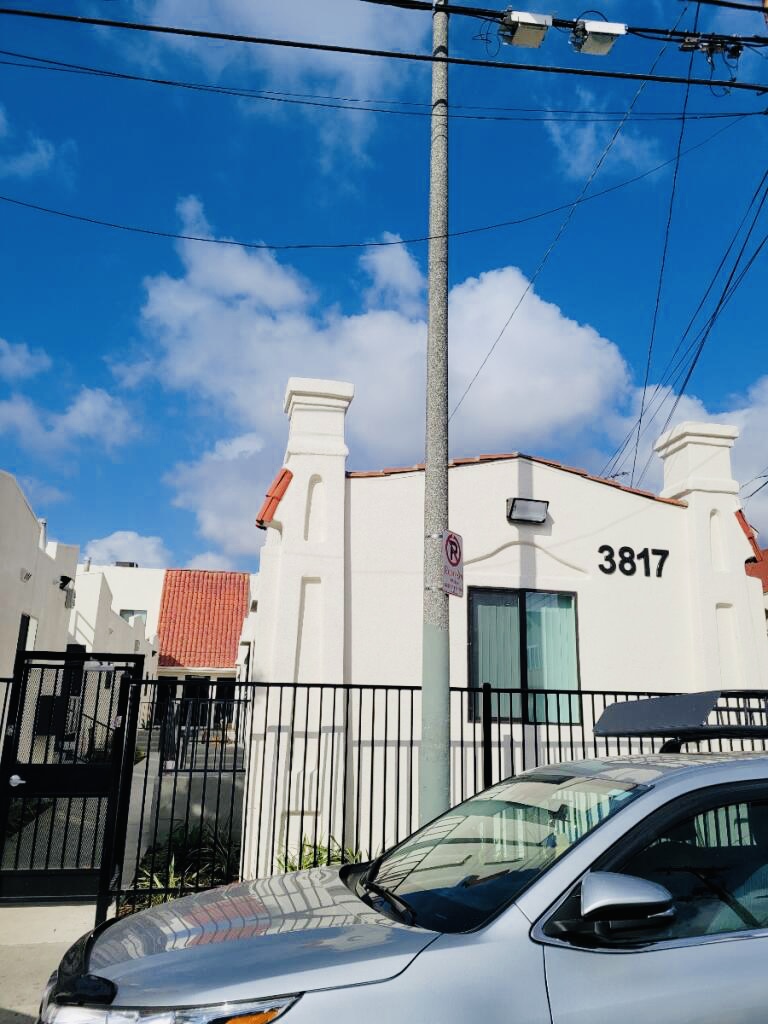 Street view of the photo of the outside of the building with a black security gate.