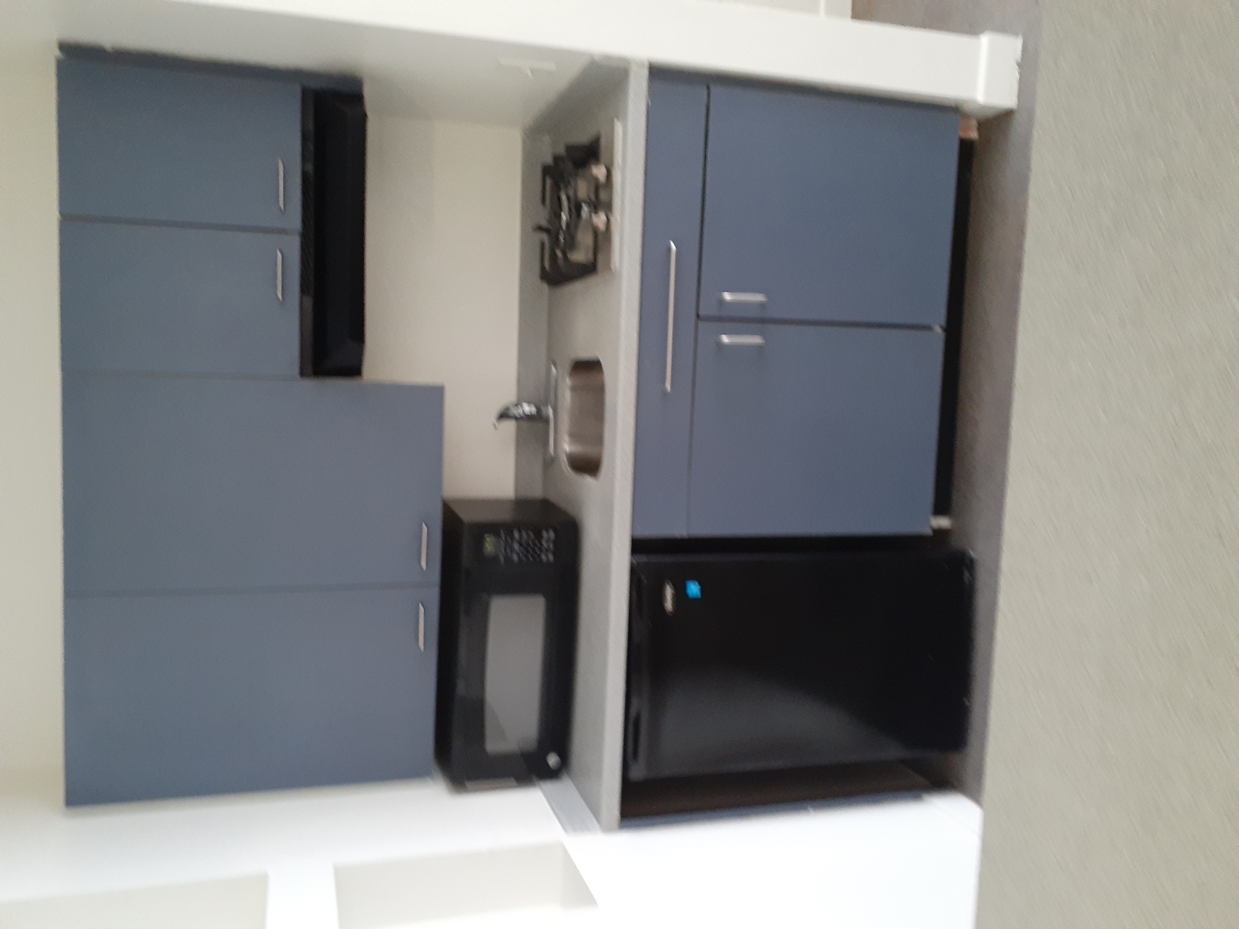 Image of the apartment kitchen with blue cabinets