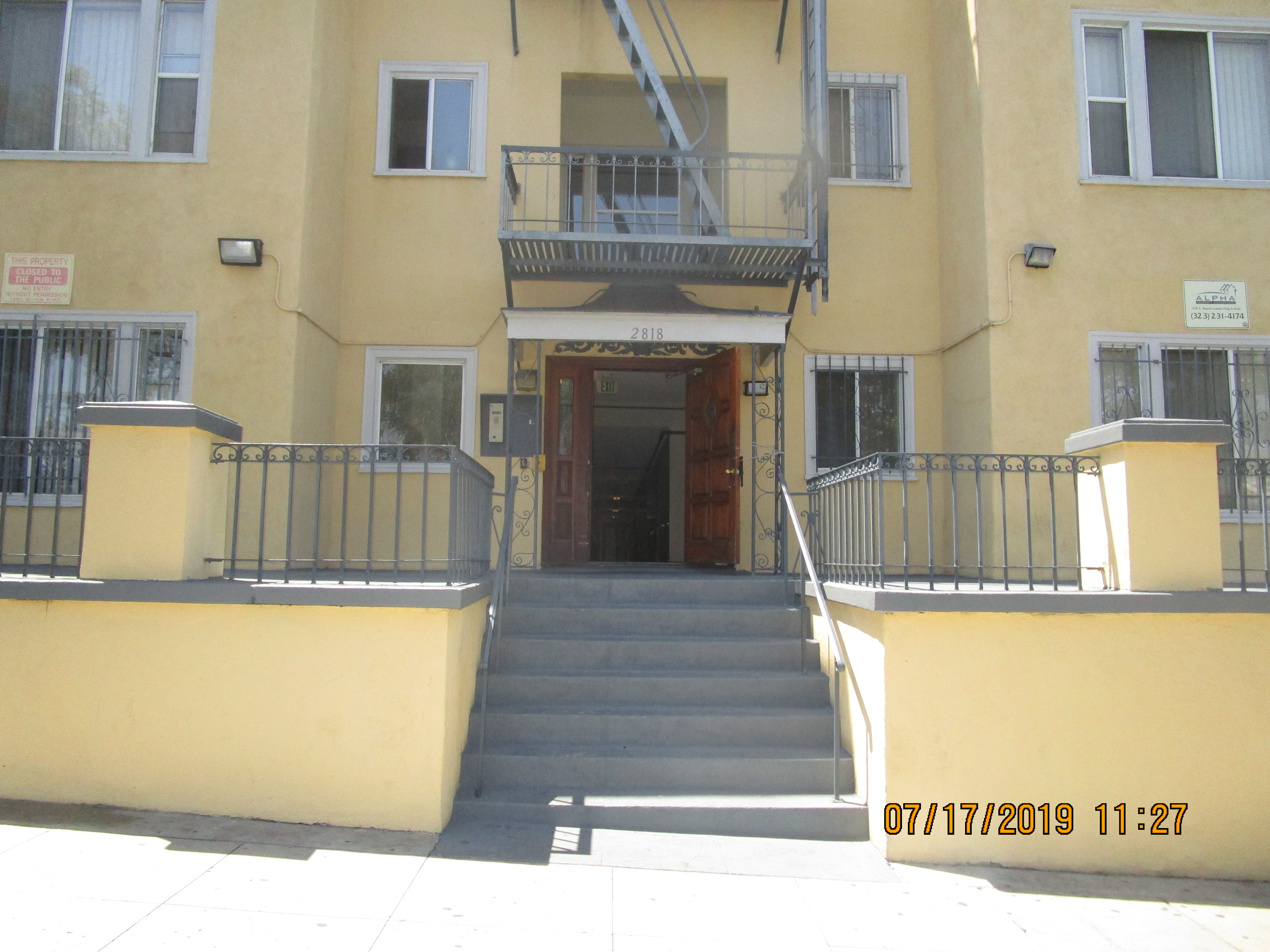 Exterior view of the entrance to Leeward A&B Apartments with steps leading up to it