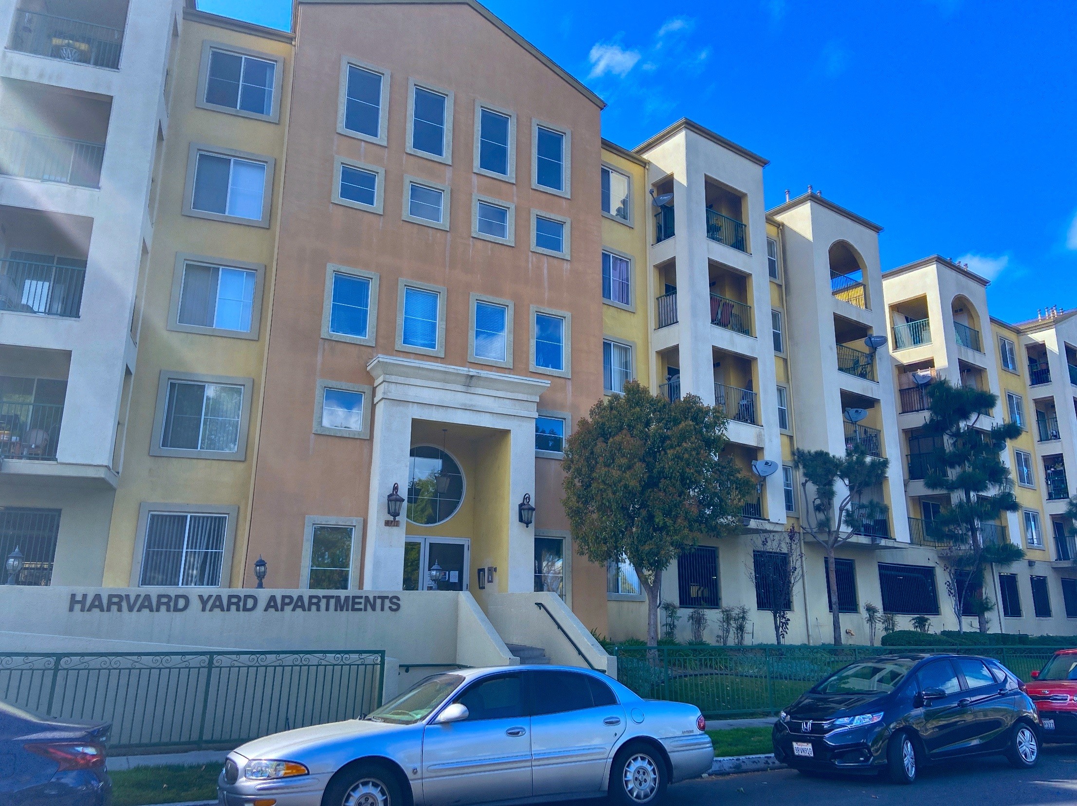 The street view of the building. The building is multi colored.