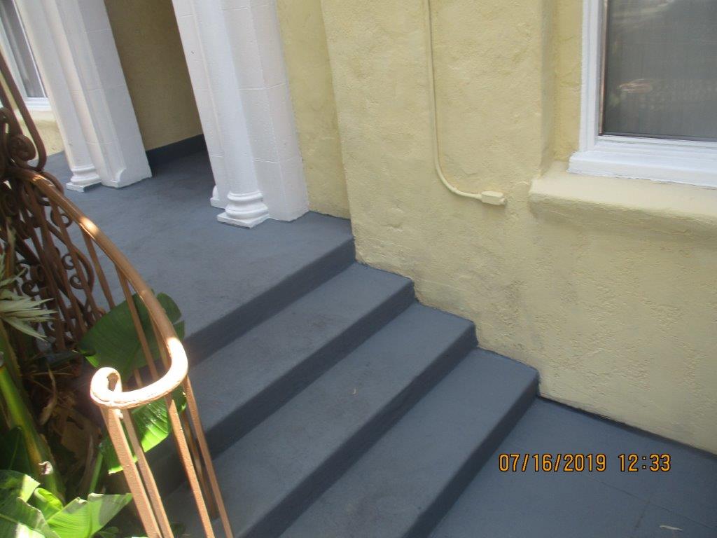 Close up view of side steps leading to an entrance of the property.