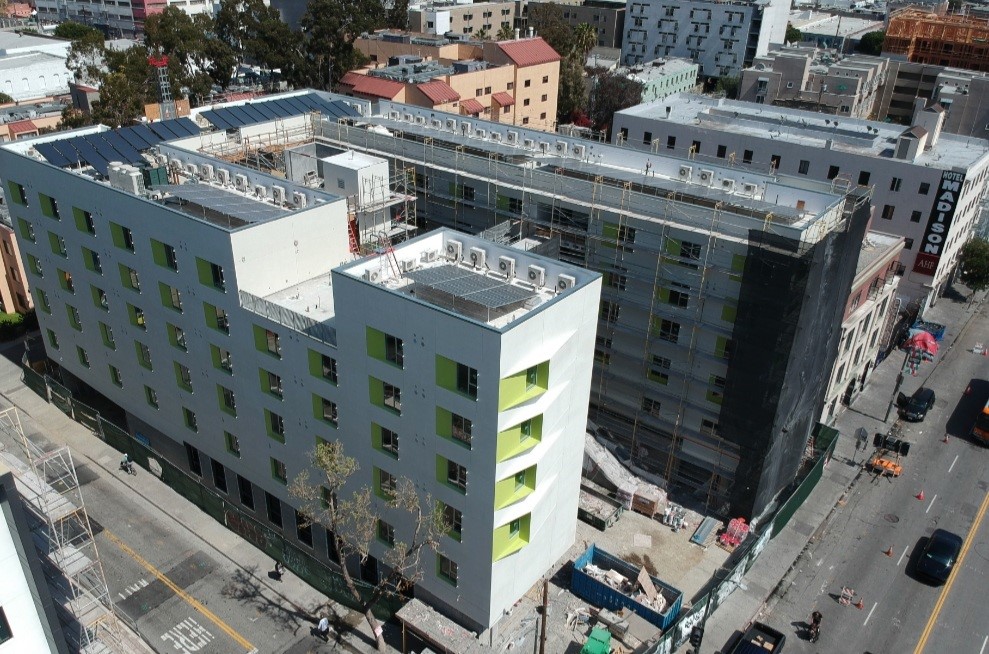 Top view of a five story building in green and grey color