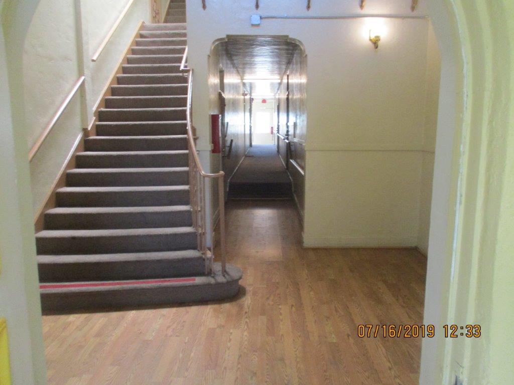 Interior view of stairs leading to the upper level and hallway on the ground floor of the property.