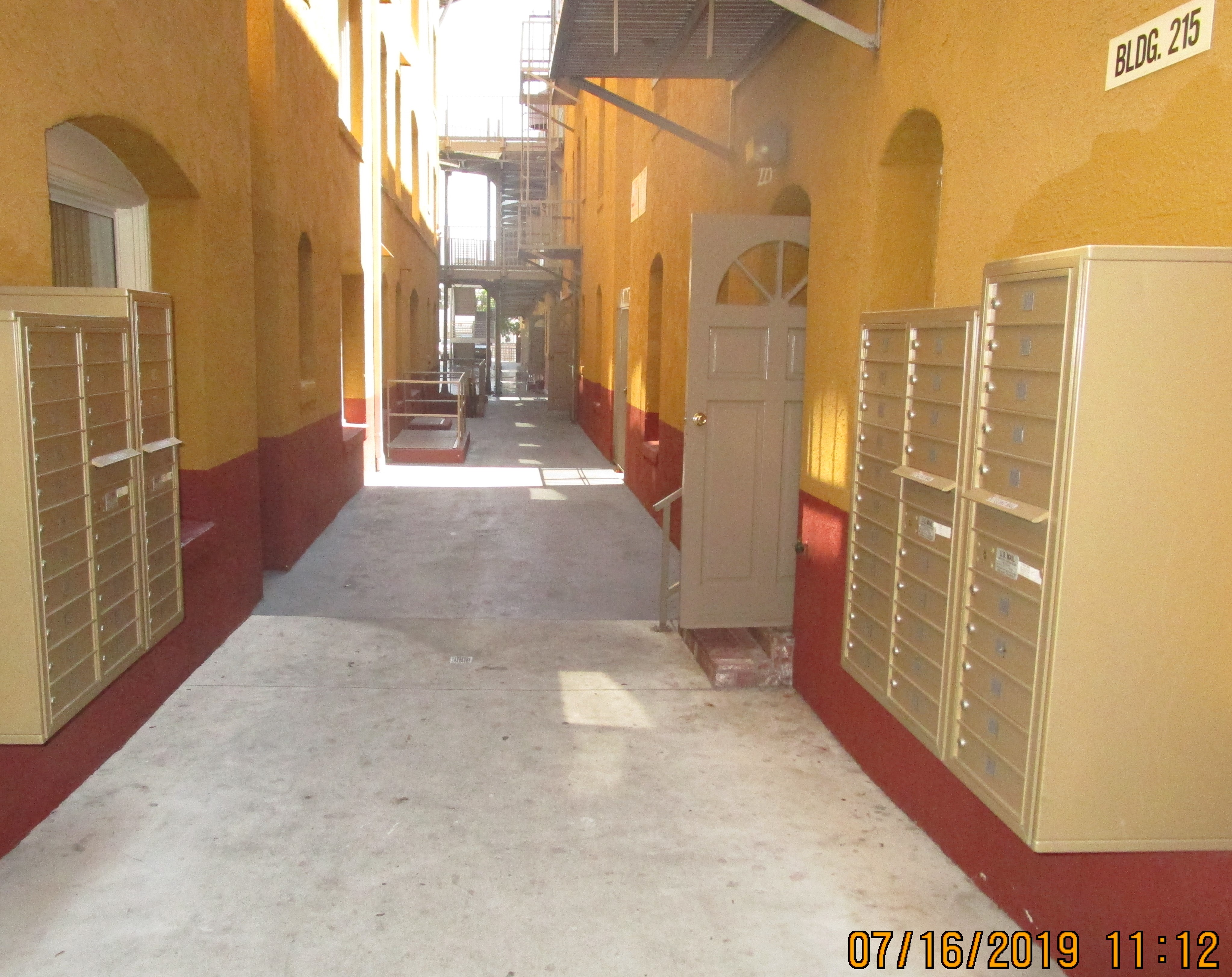 View of open hallway, units, mailboxes on each side.