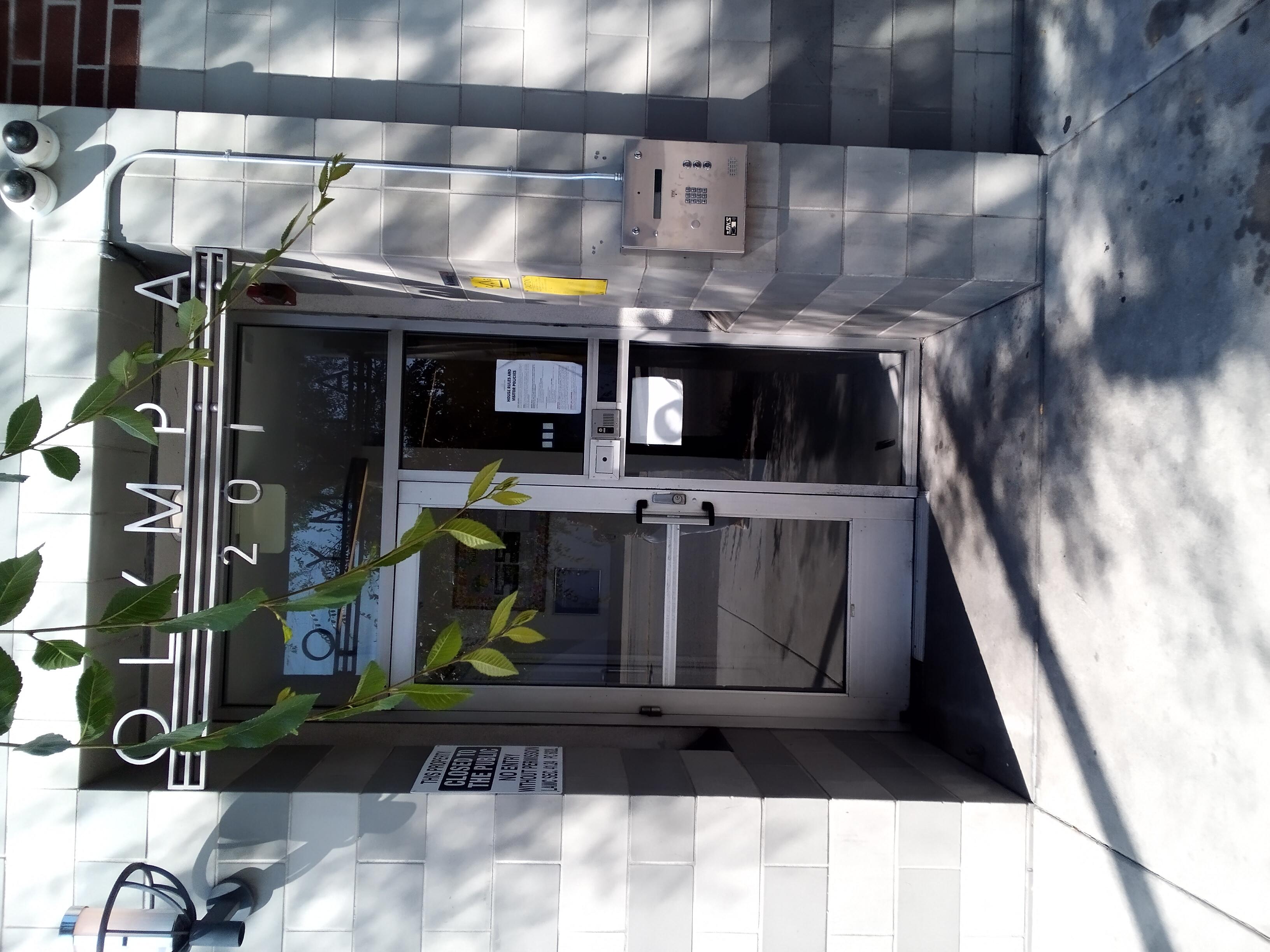 Front entrance of Olympia Hotel with gray brick.