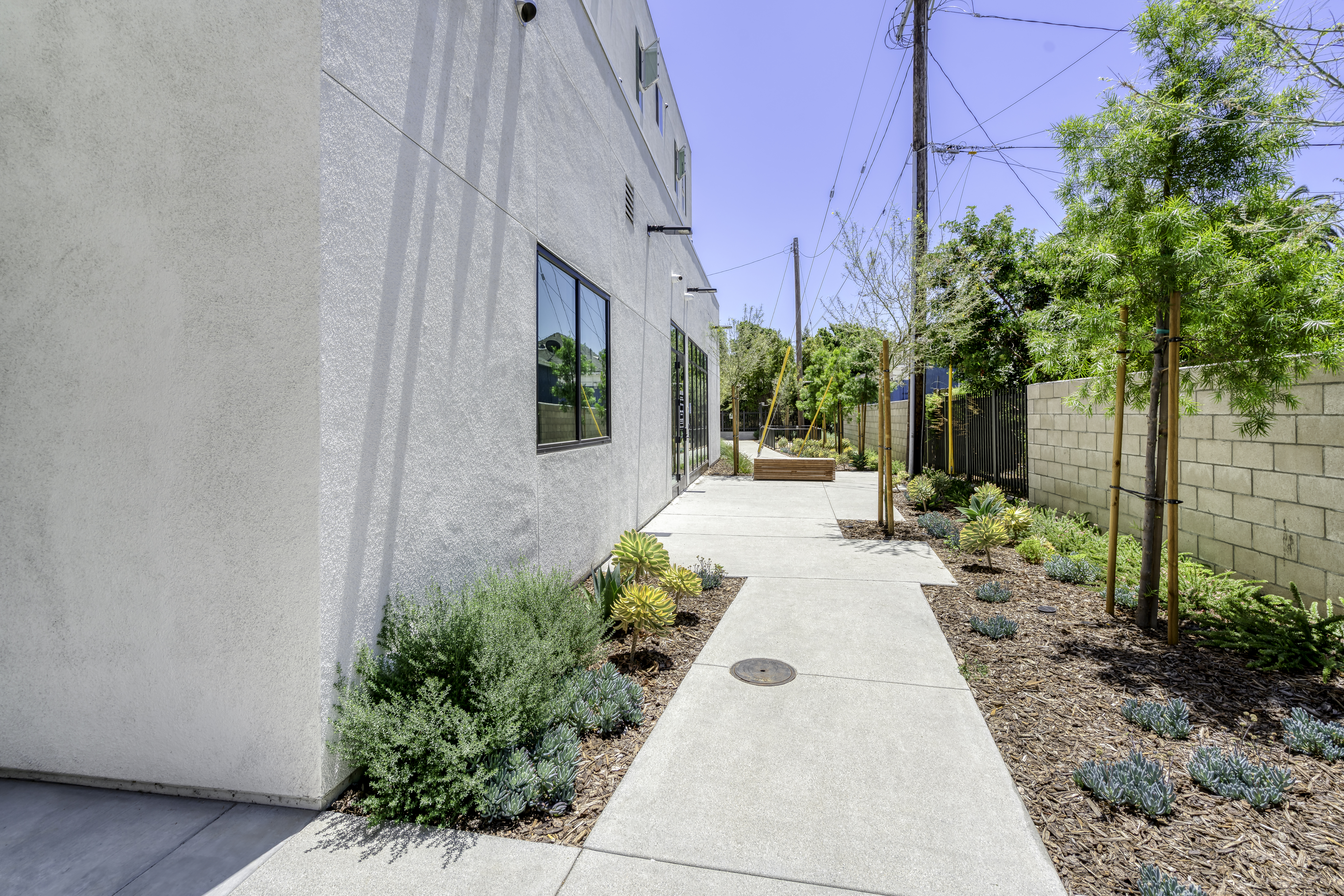 The back side of the building with sidewalk leading around.