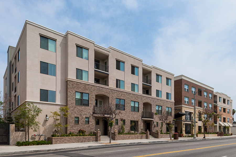 Street view of Jefferson Building. Four story building with stairs leading to front entrance. Balcony access to select units. Street parking available