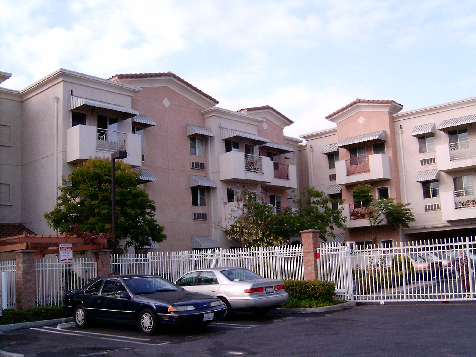 gated Three story building with outside parking on either side
of gate. Select units with balcony
