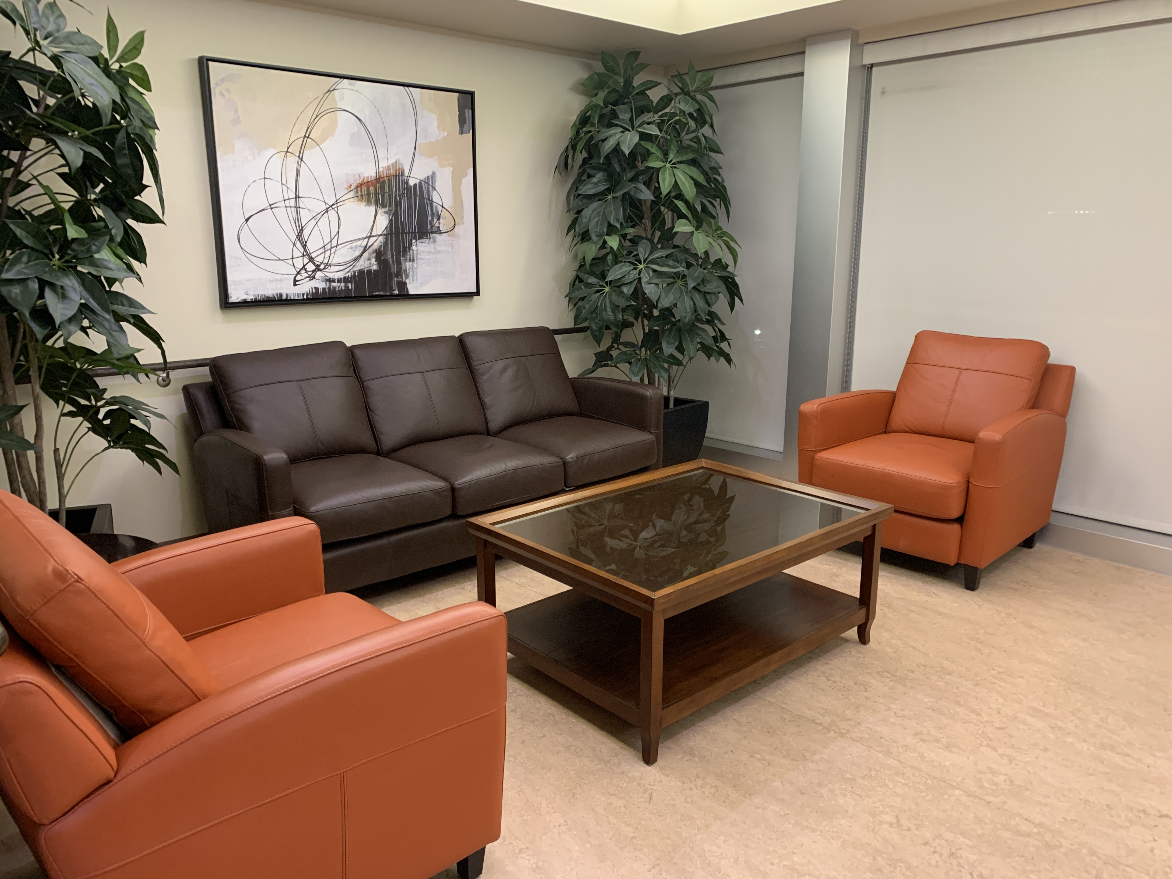 willis avenue lounge area, one is located of each floor. Room with sofa and chairs with coffee table/ decroative art and plants in room