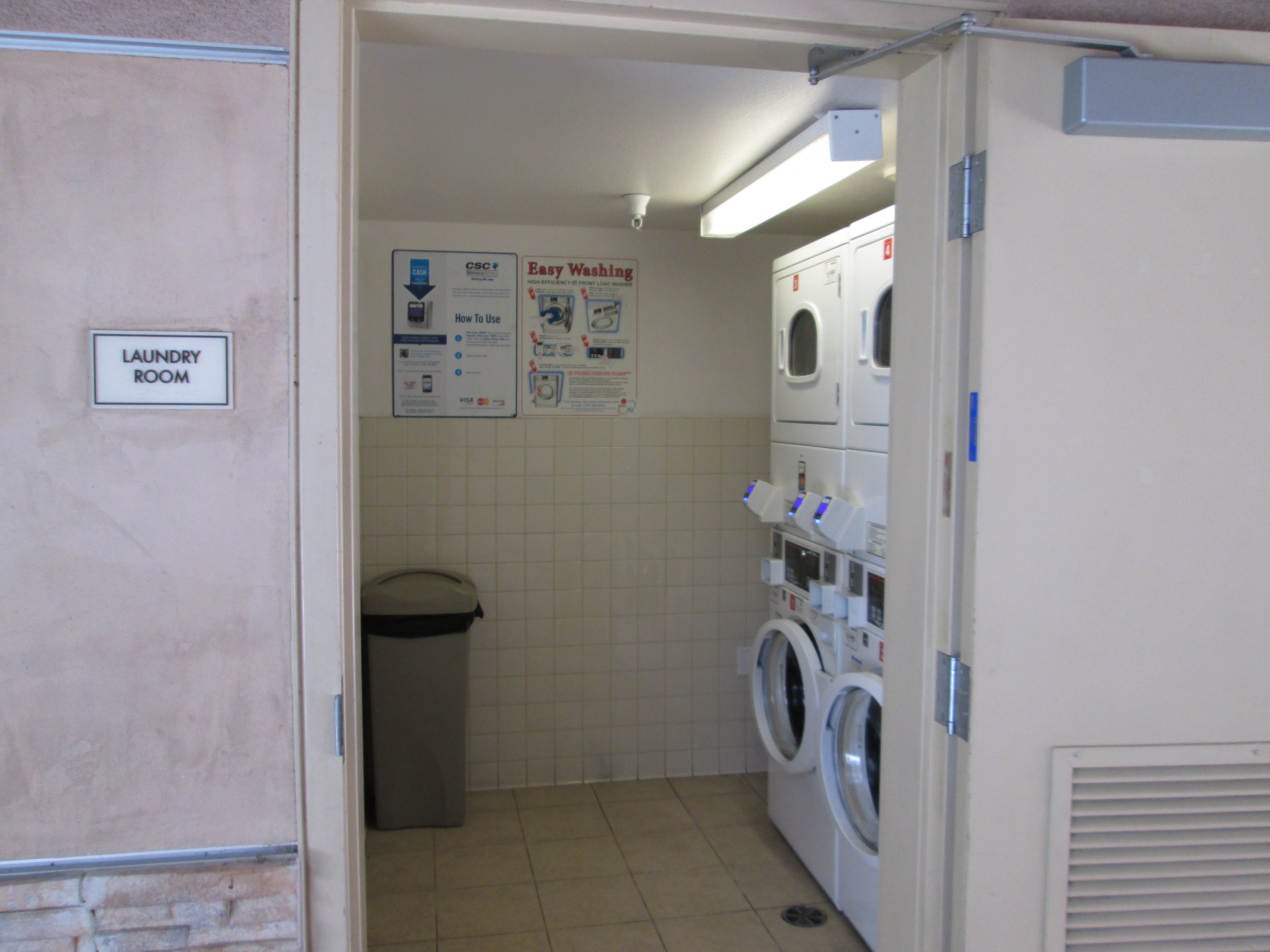 View of a laundry room at Cuatro Vientos showing two washers and two dryers