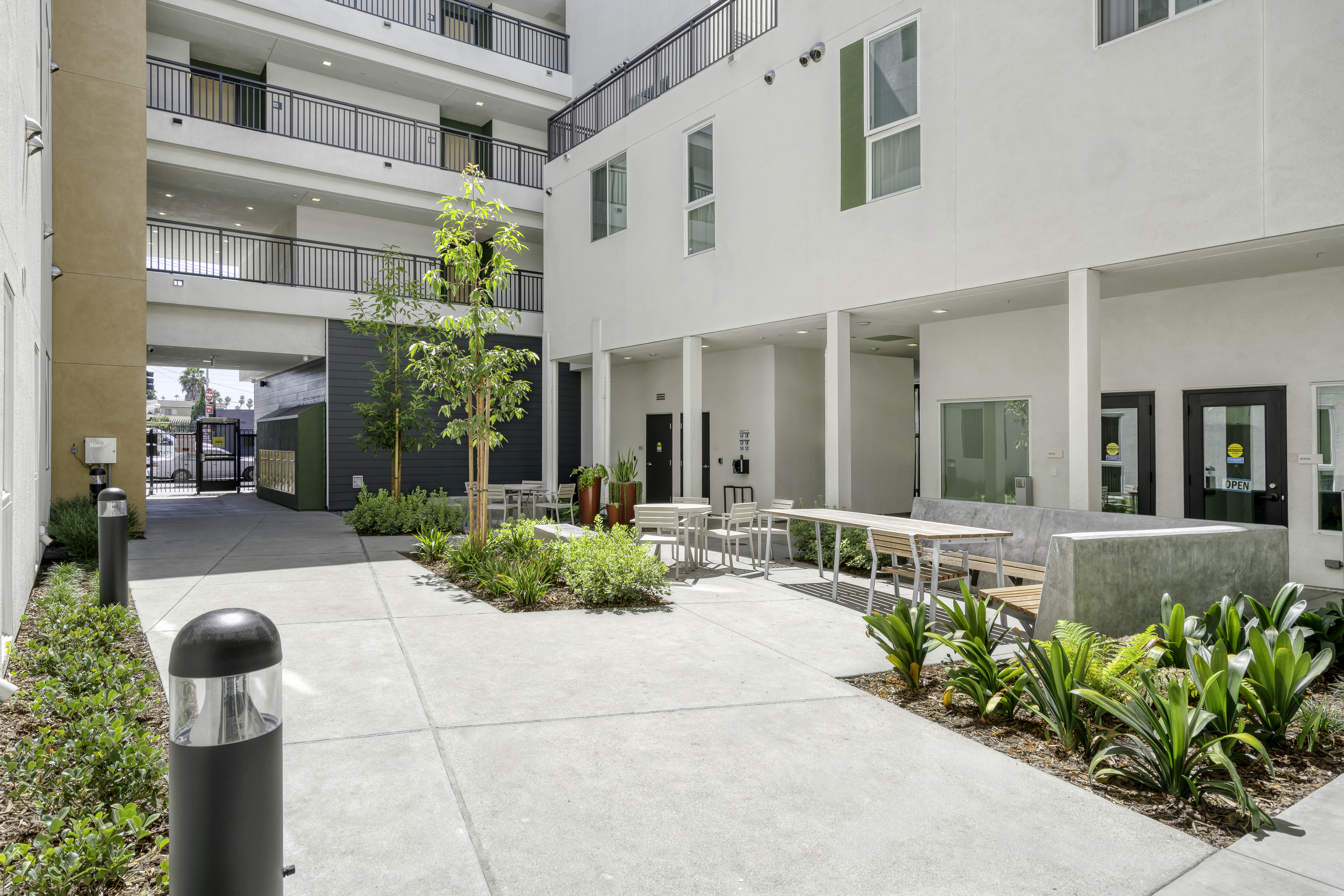 Common Area. The courtyard view of the entrance/exit gate with seating area on the right.
