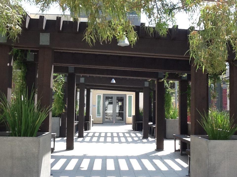 Exterior view of the courtyard at Rio Vista Apartments. Covered walkway with landscaping