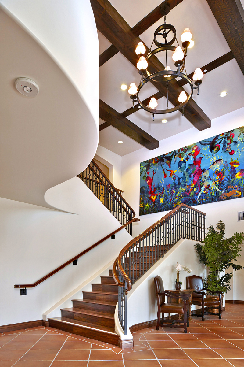 Image of property lobby with a painting on the wall and brown stairs