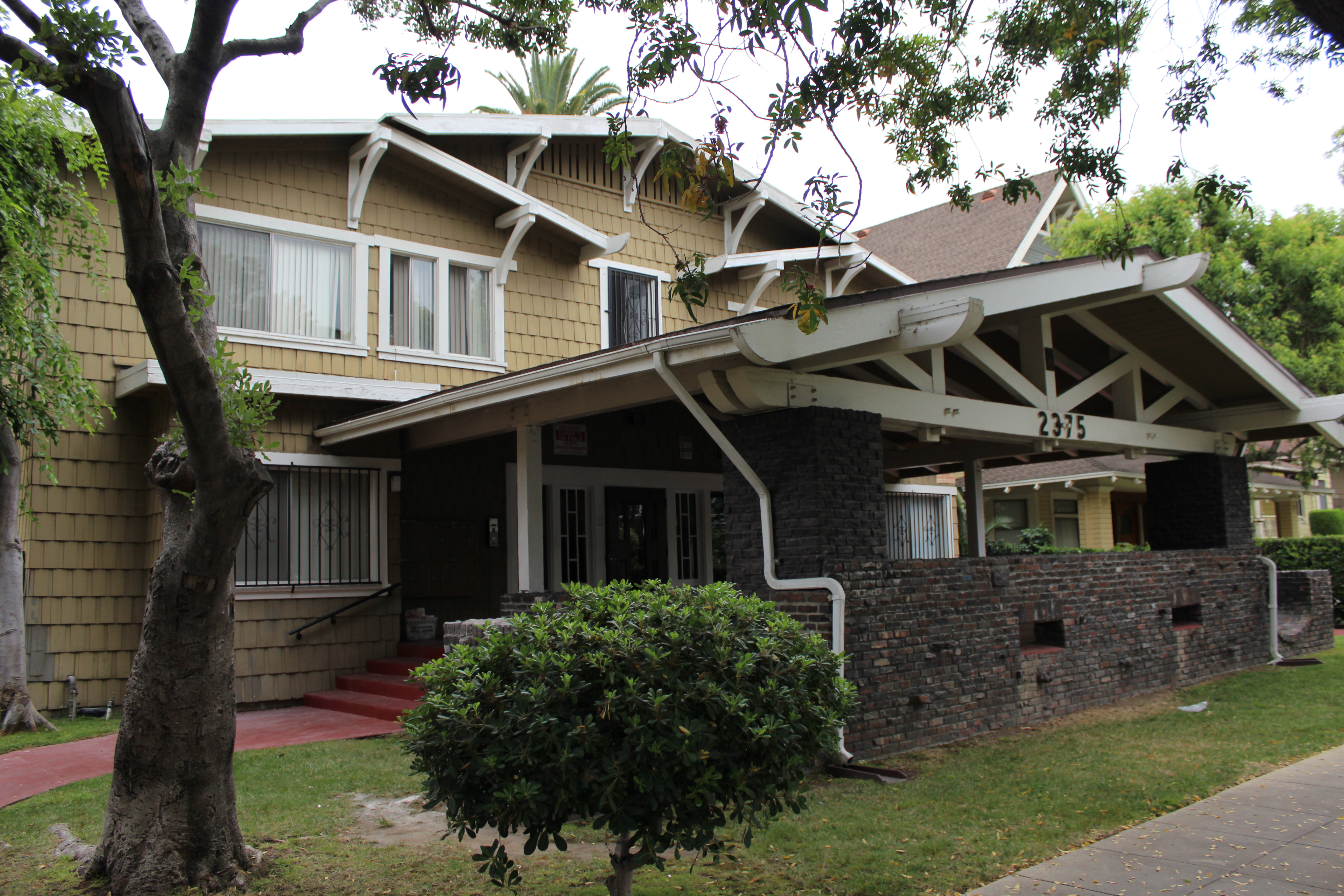 View of the front porch and the two story Craftsman style building.