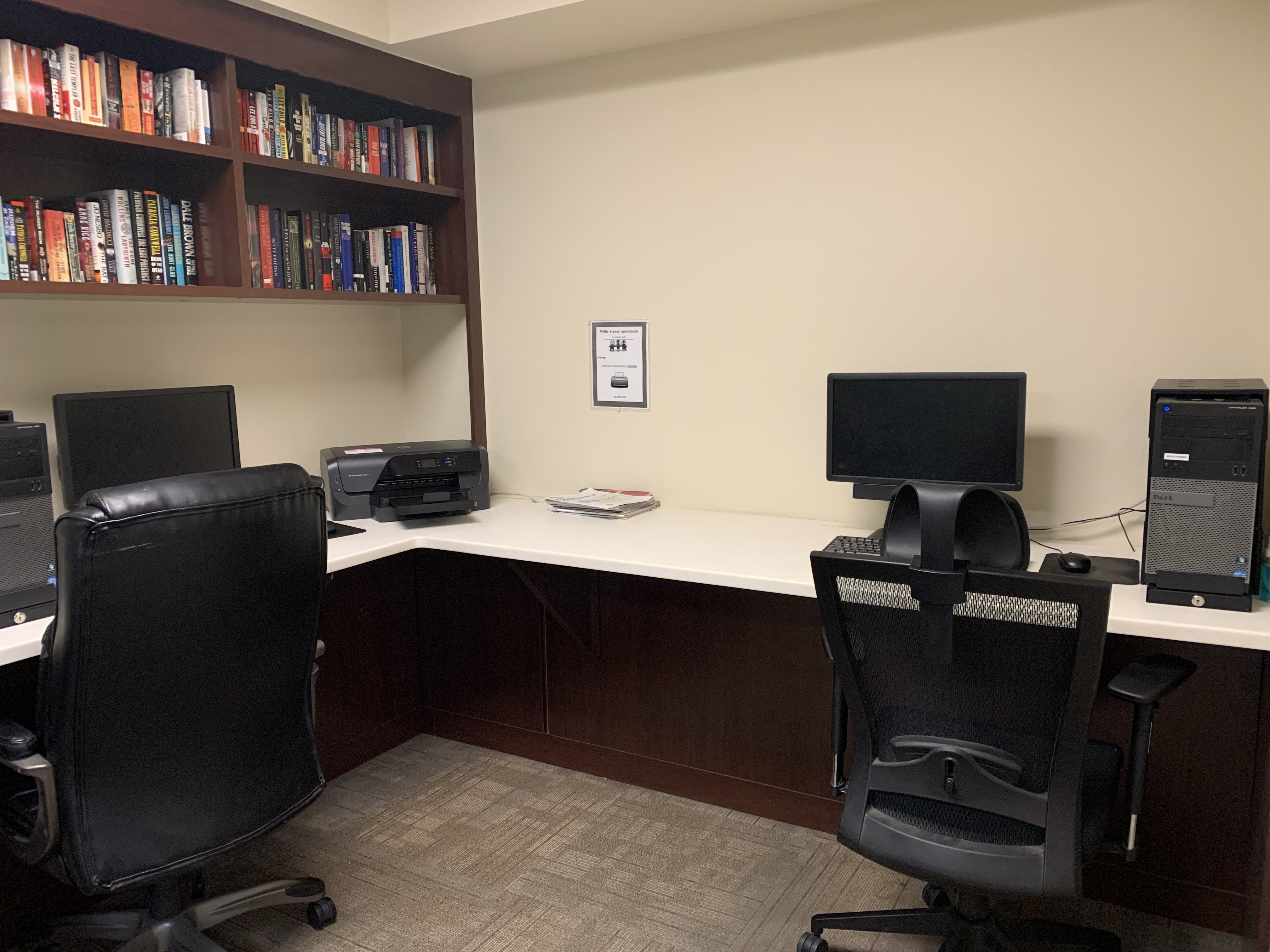 Willis Avenue computer lab. large l shaped desk with built in book shelf. Computer desktops and printer