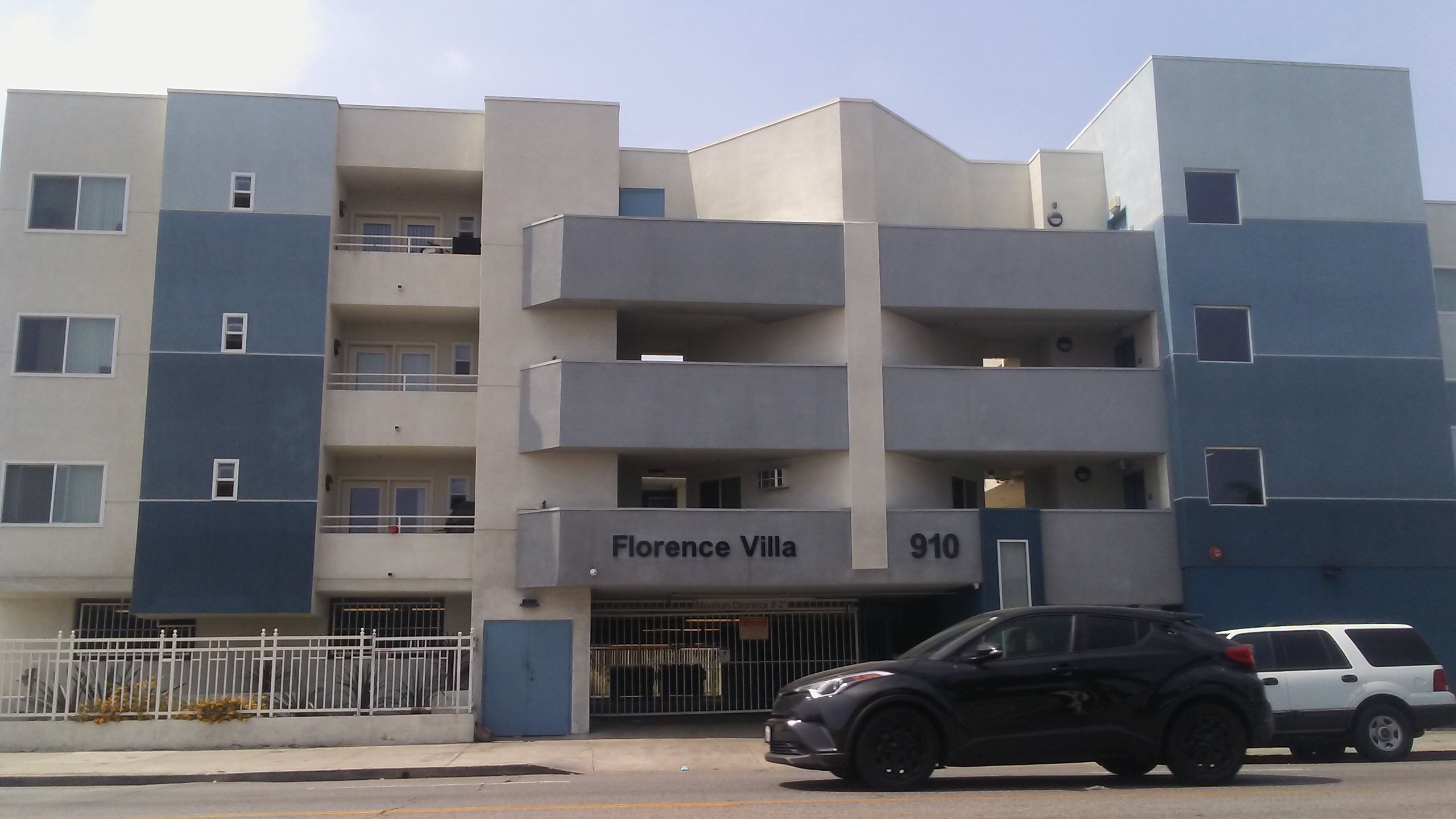 Street view of Florence Villa. Four story building with parking gargae. Units with balcony access.