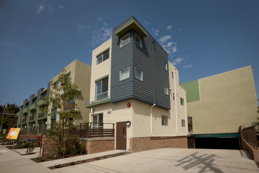 Exterior - Three story with shades of green, blue and brown. Entry way into parking structure.