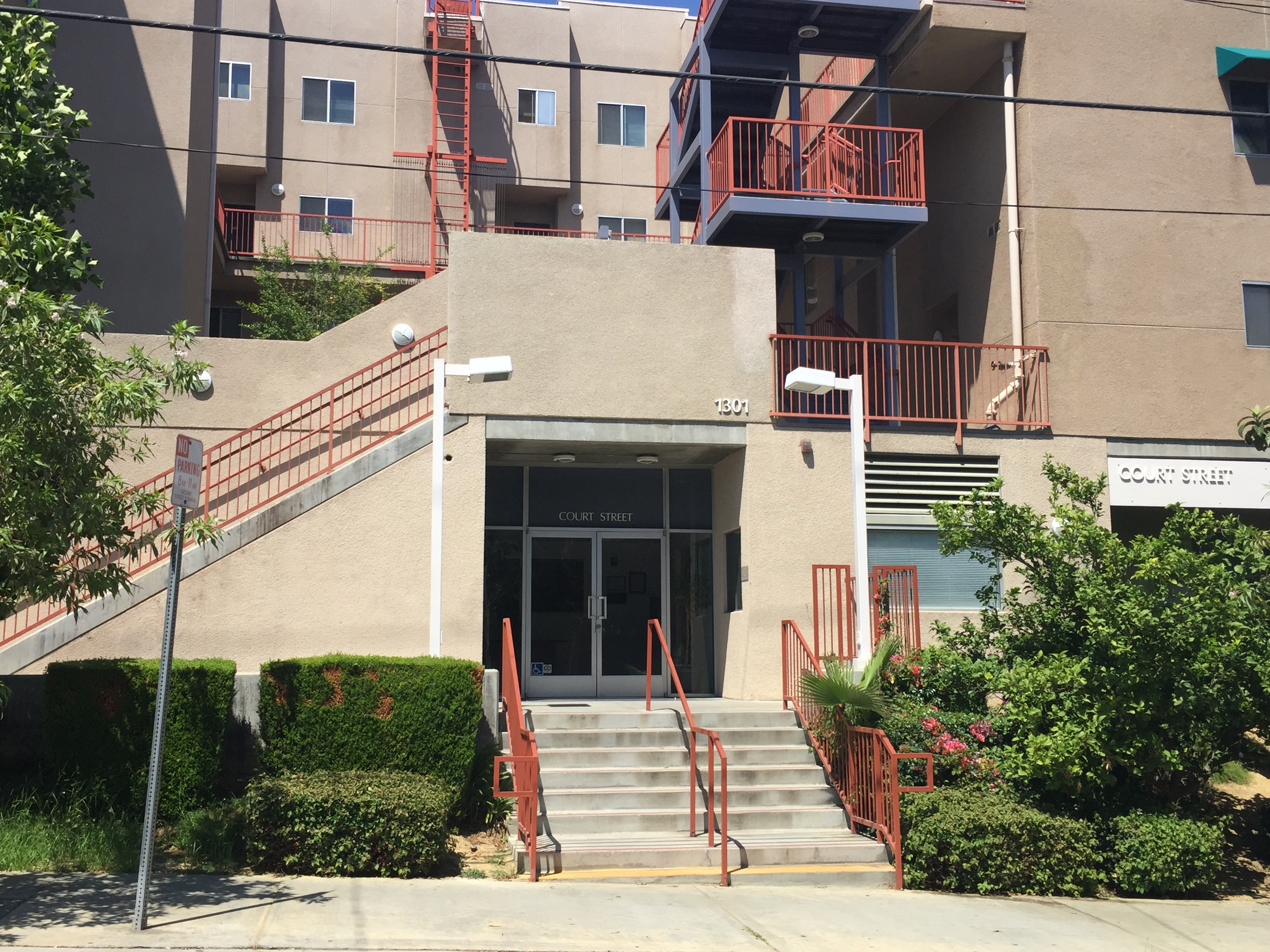 Street view of a three story building in biege color