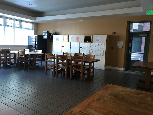 image of courtland dining area. multiple seating and tables. vending machine, and mailboxs