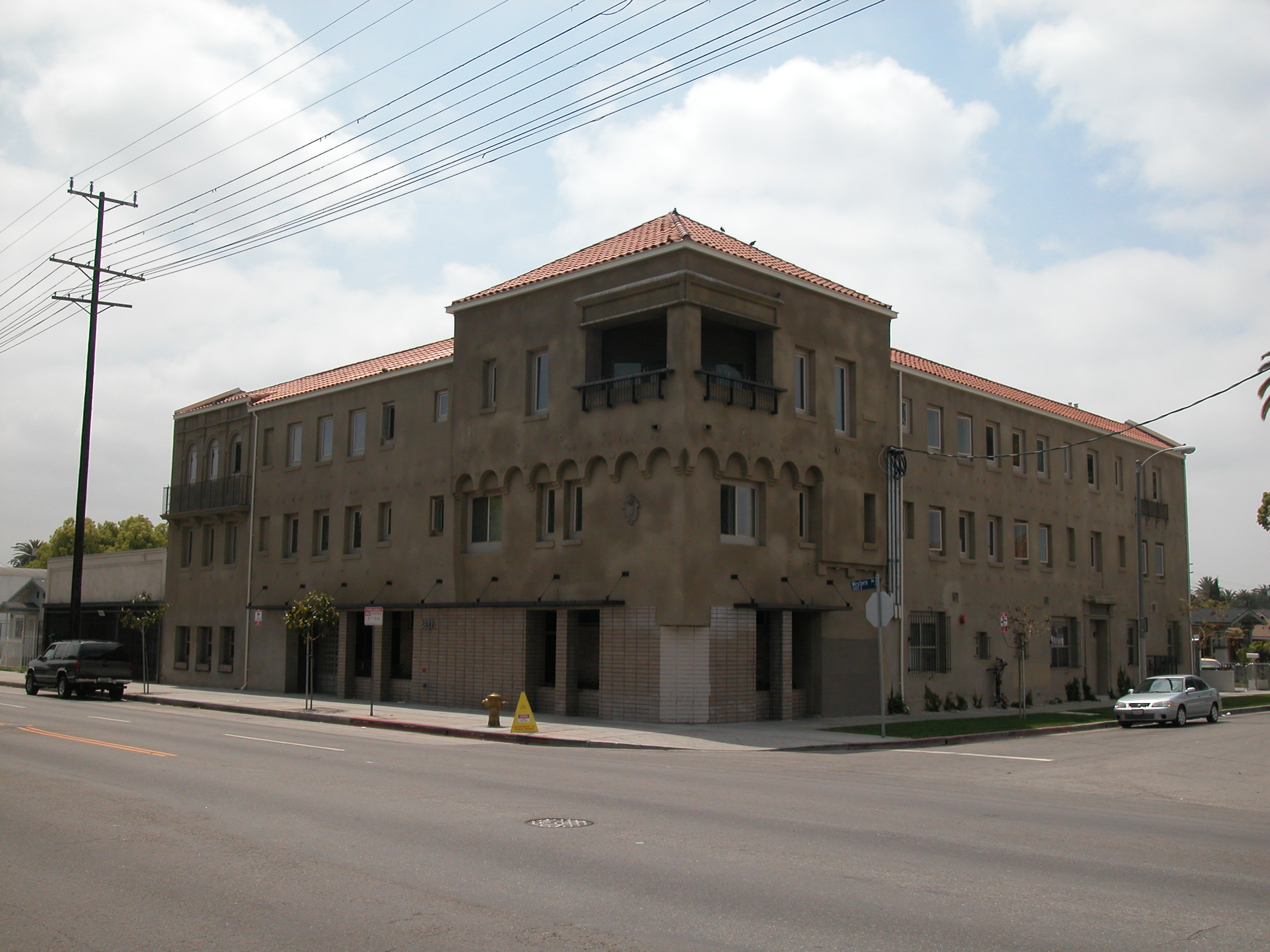 Street view of a two story brown building located on the corner of the street