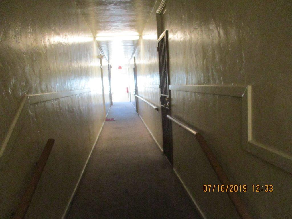 Interior view of a hallway with guardrails.