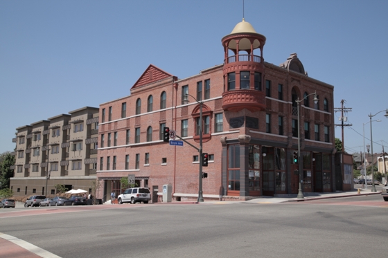 Four story building located on a corner intersection on a slight hill.