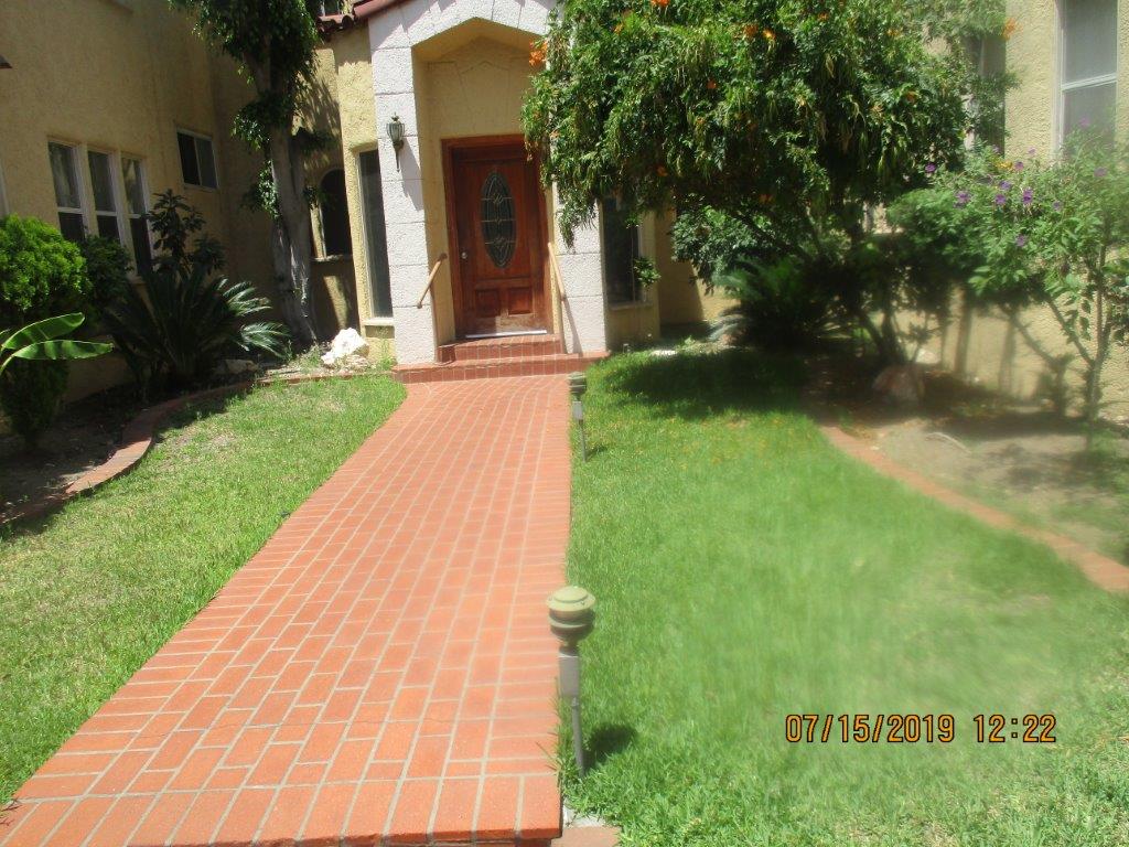 Image of brick walkway leading the the entance of property