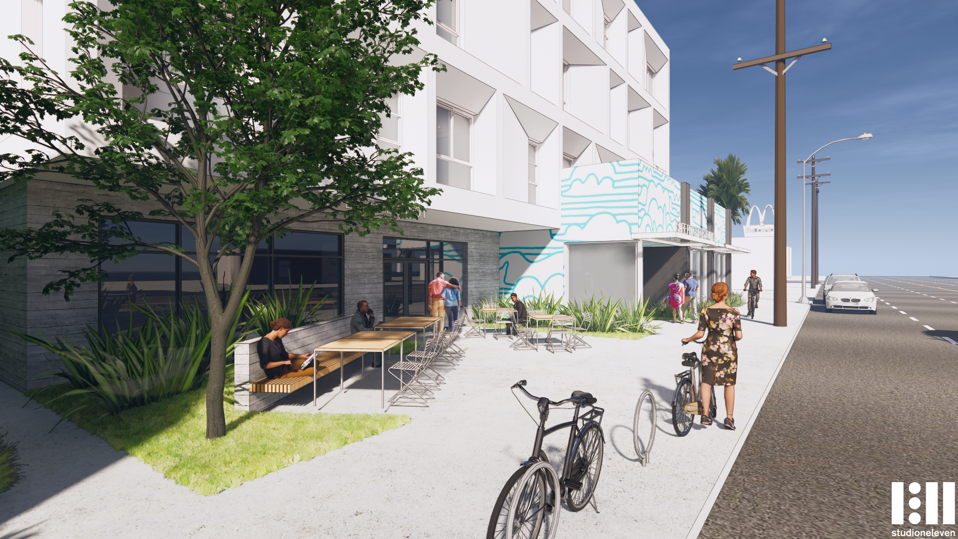 Renderings of apartment complex with seating area in the front and bicycle racks in front.