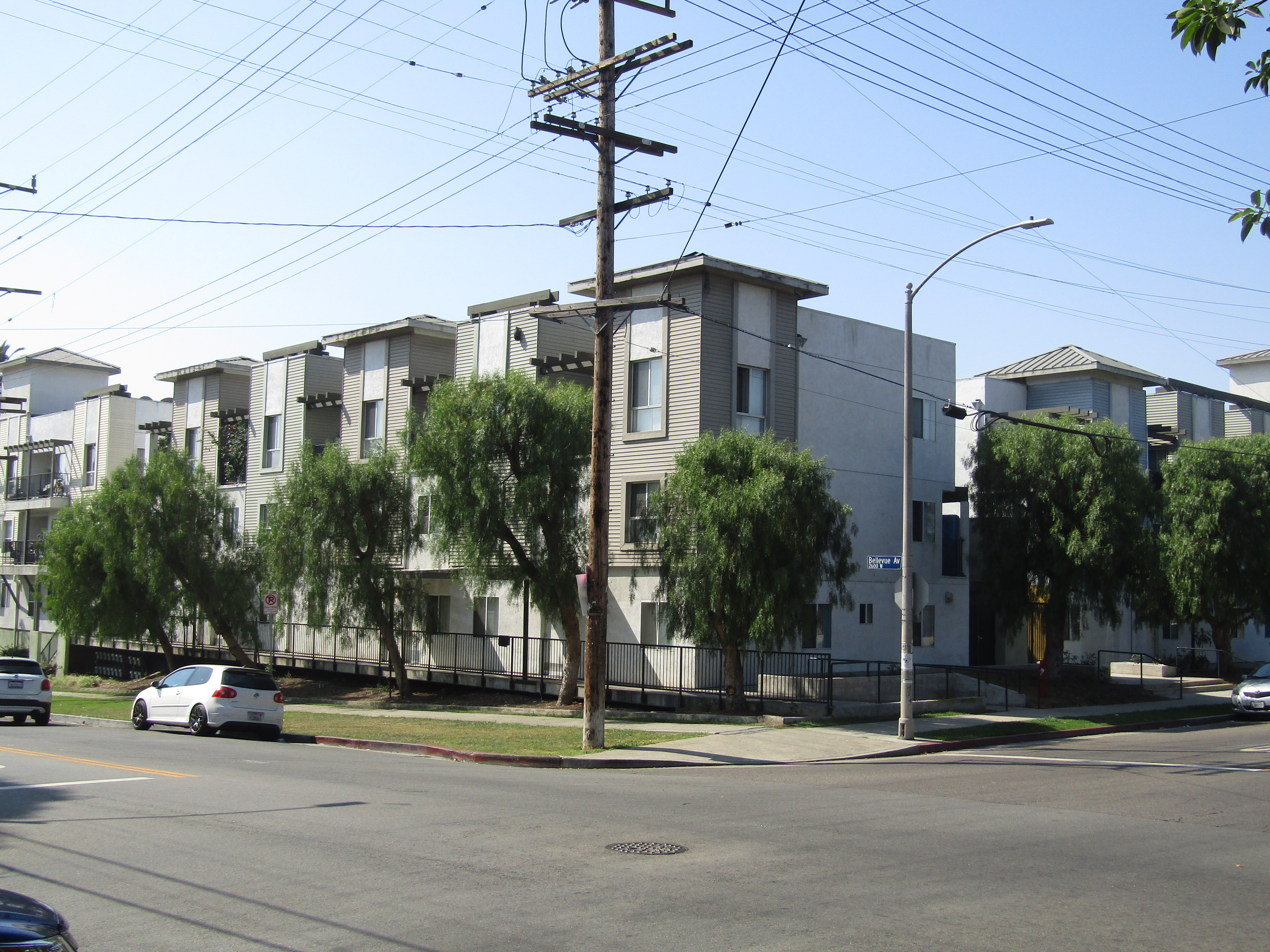 Street view of a three story apartment complez divided into several buildings