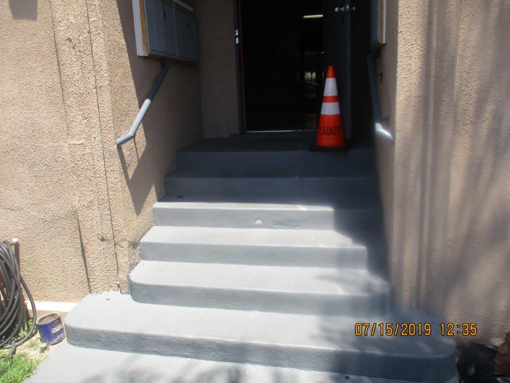 Close up view of steps leading to an entrance to the property with mail boxes on the landing before the door