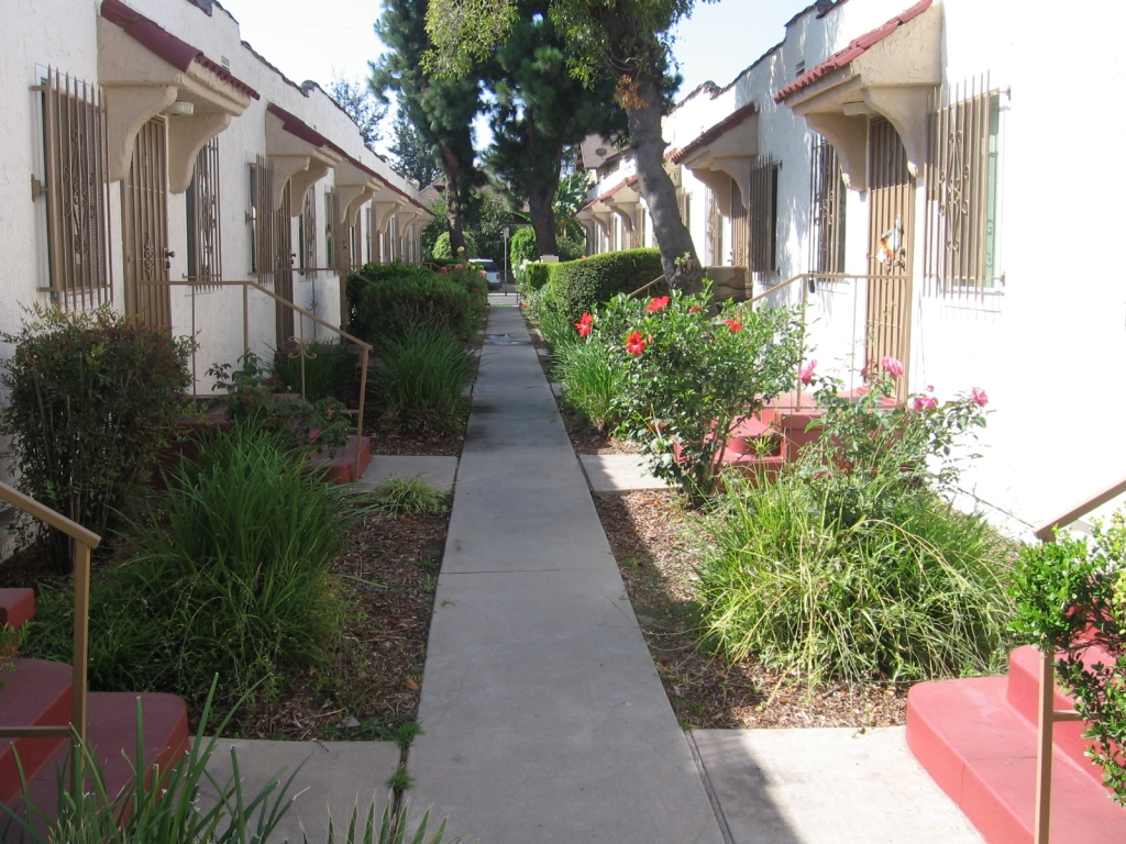 Inside view of single story apartments in brown color lined next to each other