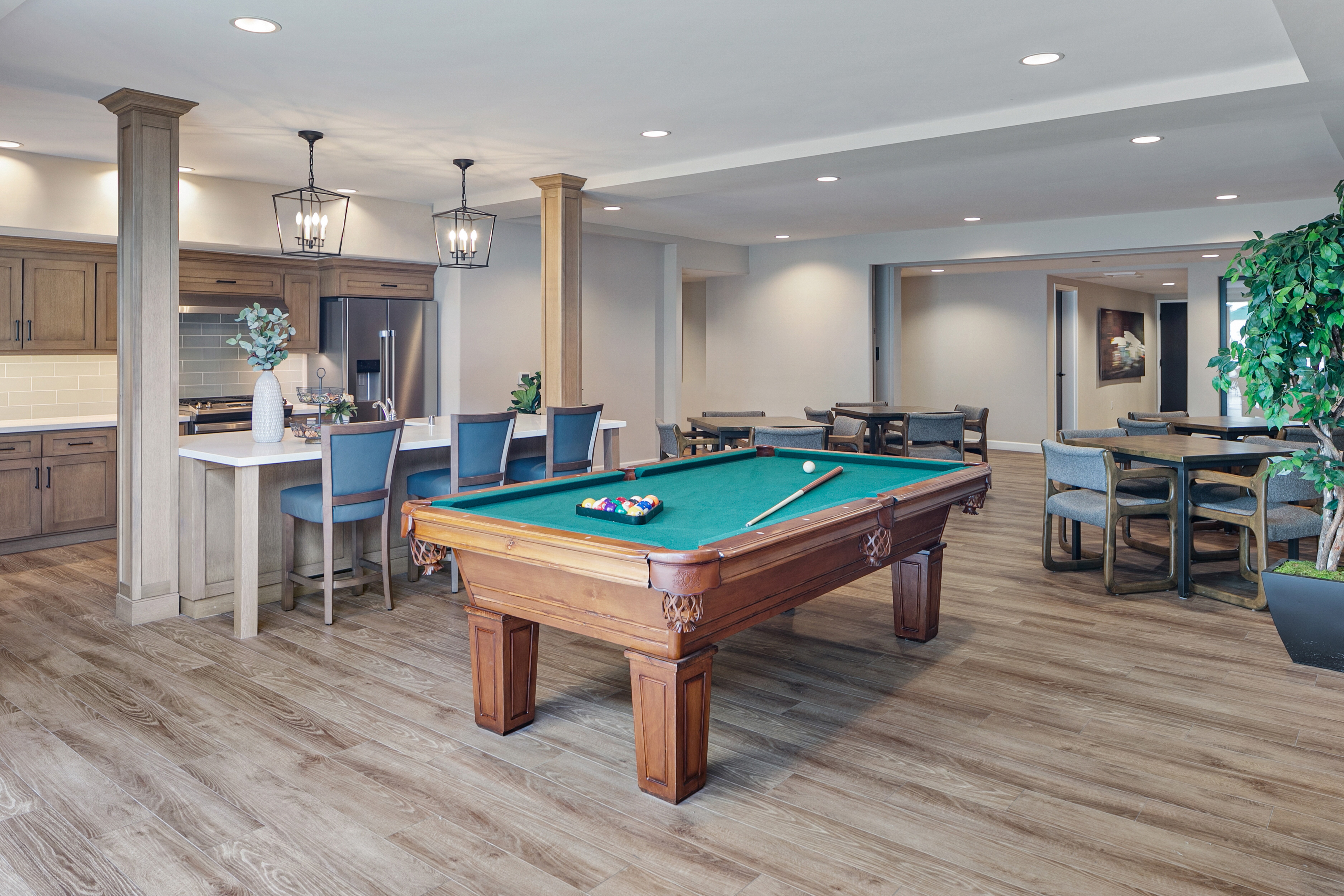 Common area with billiard table, kitchen island, and tables