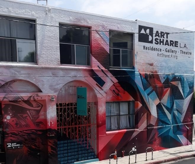 Exterior view of the front of Art Share LA Residence/Gallery/Theatre, 2 story building with a red, white, and blue abstract mural.