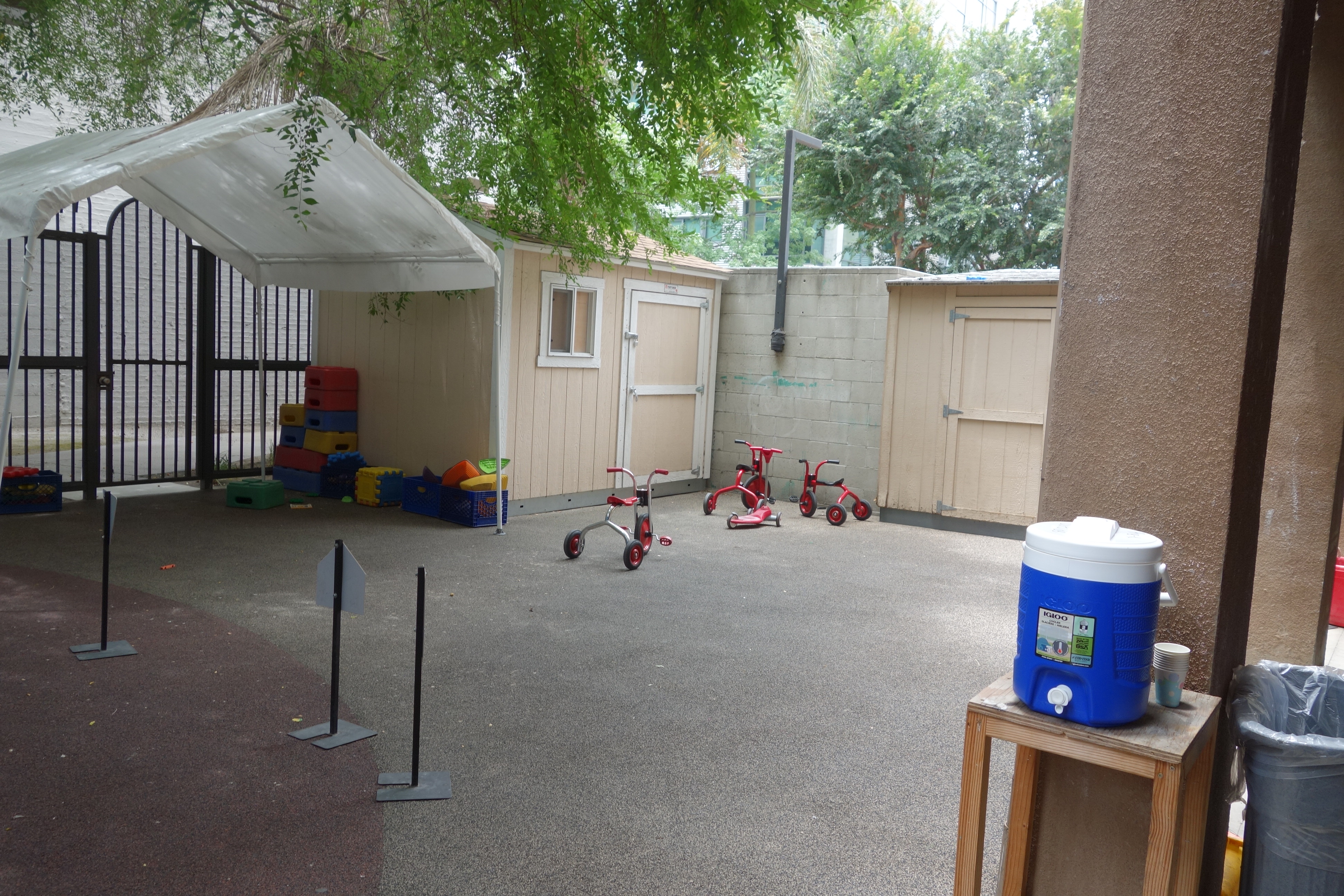 Exterior view of a play area of Hope Village. A few tricycles and building blocks