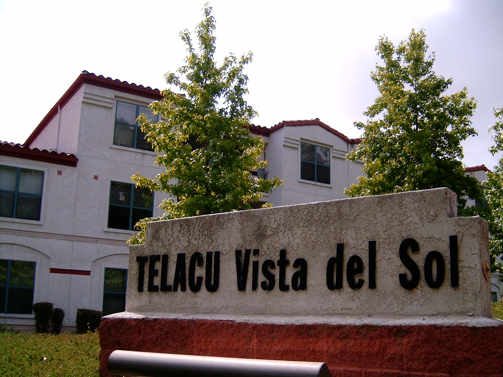 Close view of building sign of Telacu vista del sol with 
building in the background