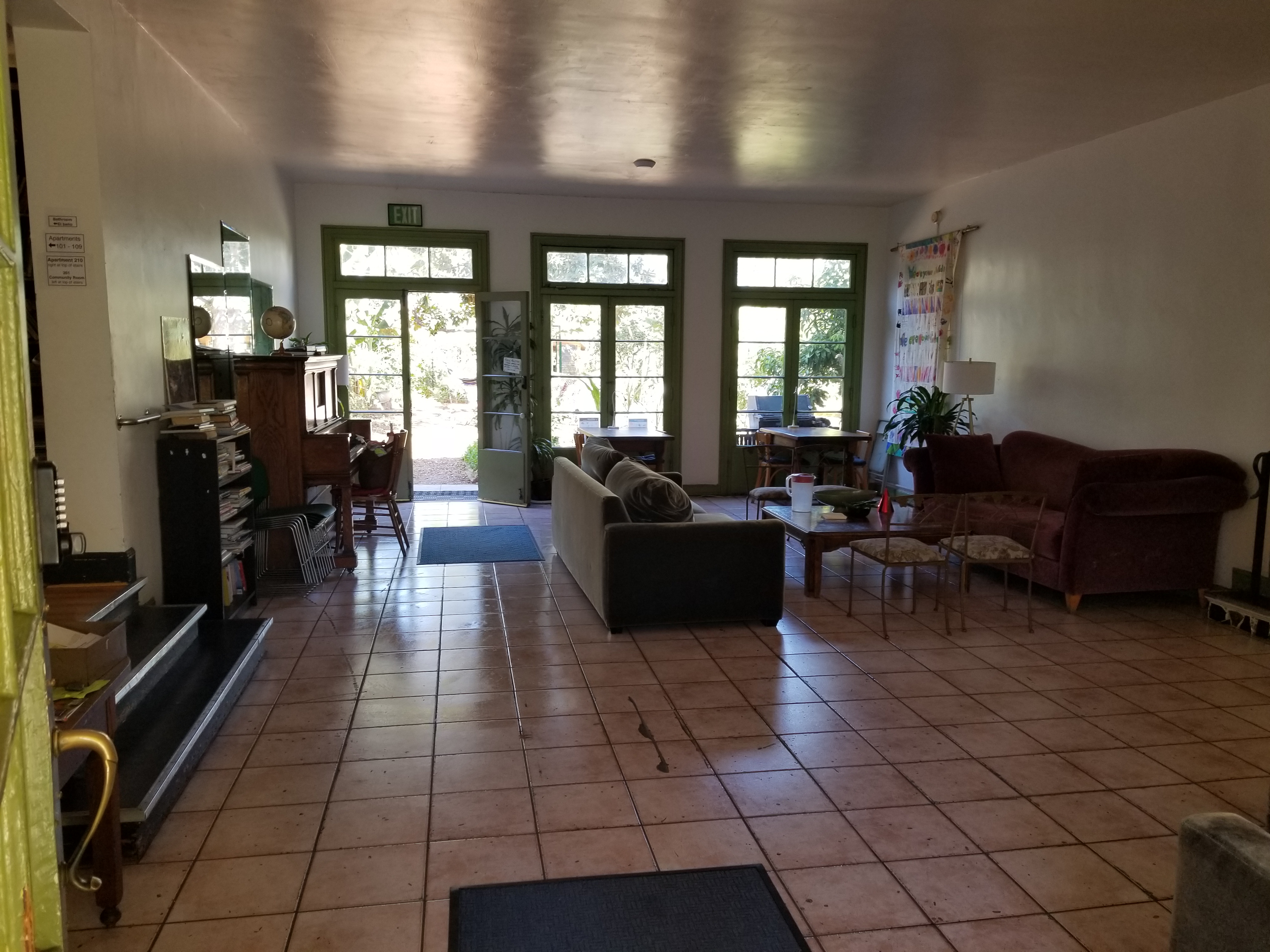 Interior view of the lobby/common area of Ecovillage with couches and coffee table