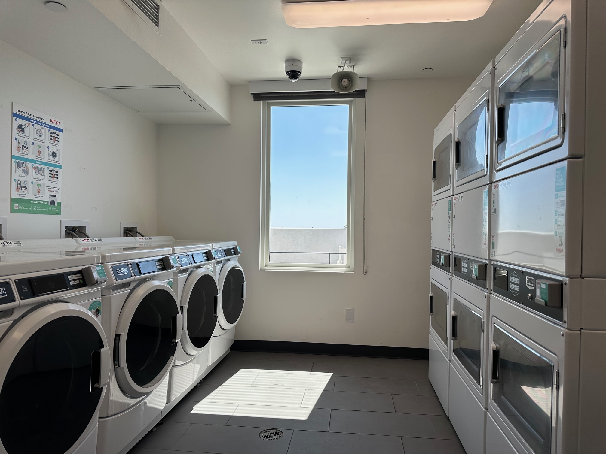 Property Pictures of laundry facility including 4 washers and 6 dryers.