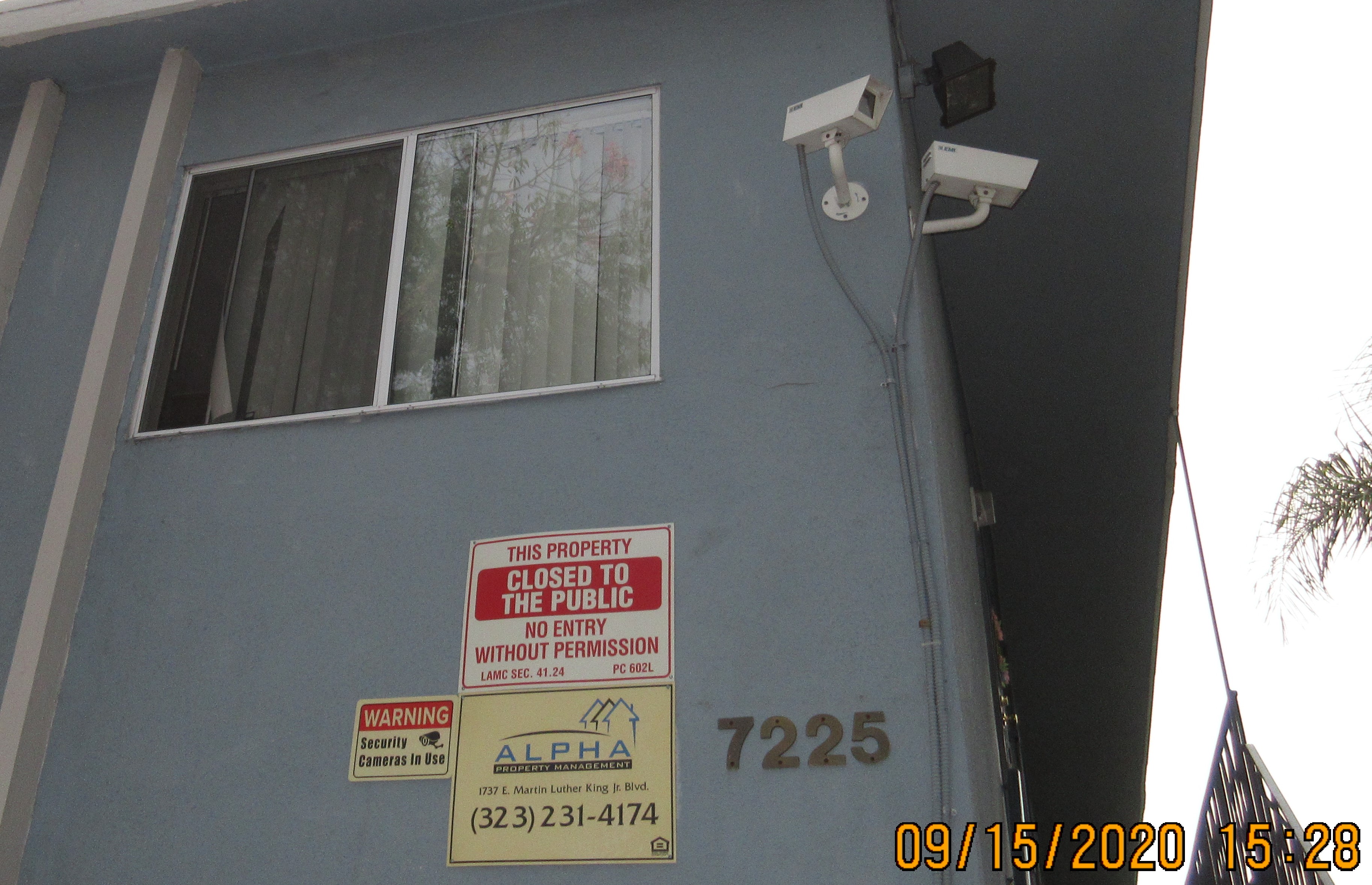 View of private property and management signs on the wall and security cameras.