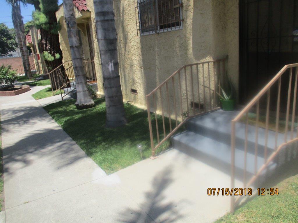Exterior view of a entrances to a few units with two steps each to the front door.