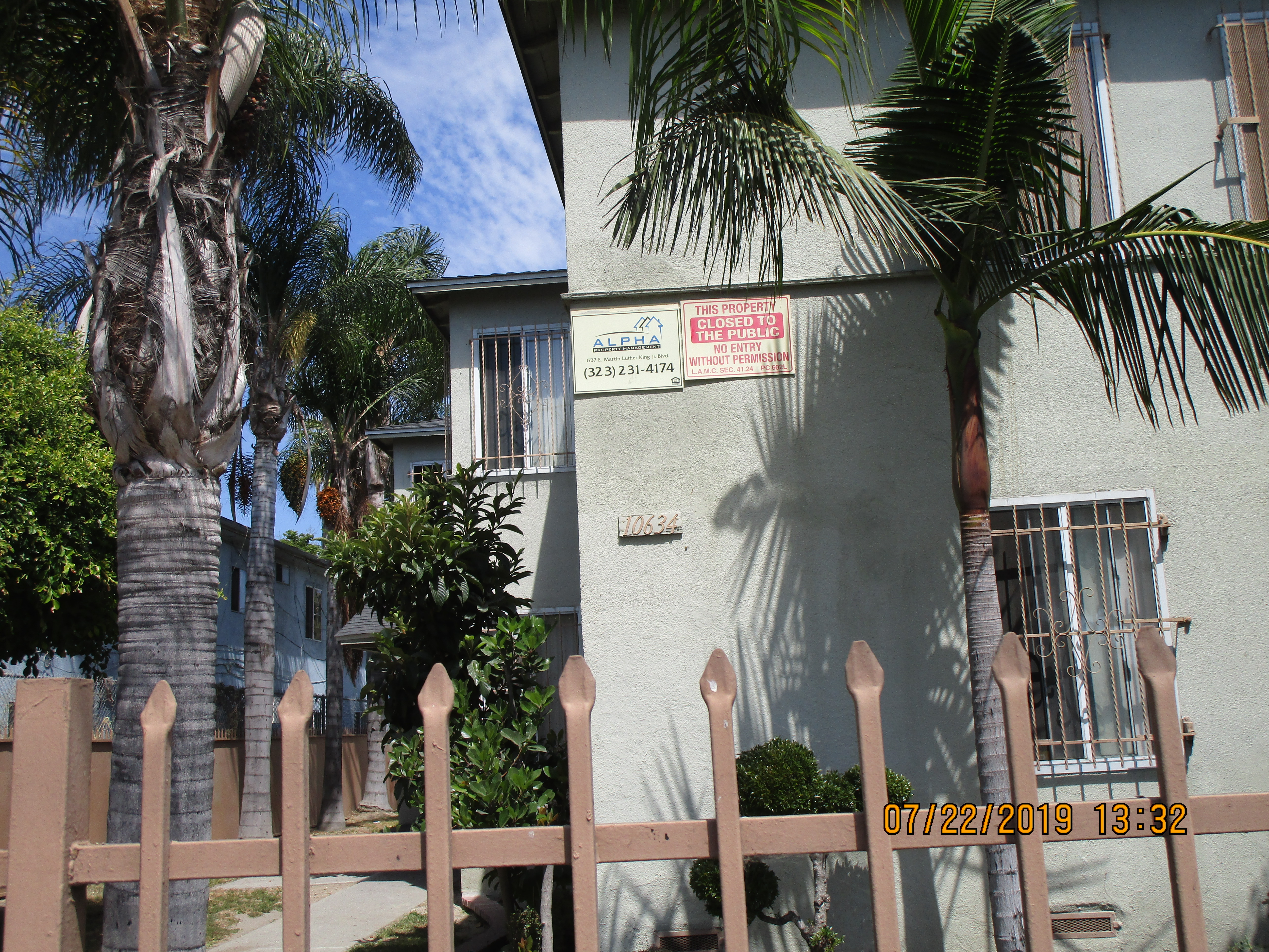 Close up view of the property with Palm trees to one side