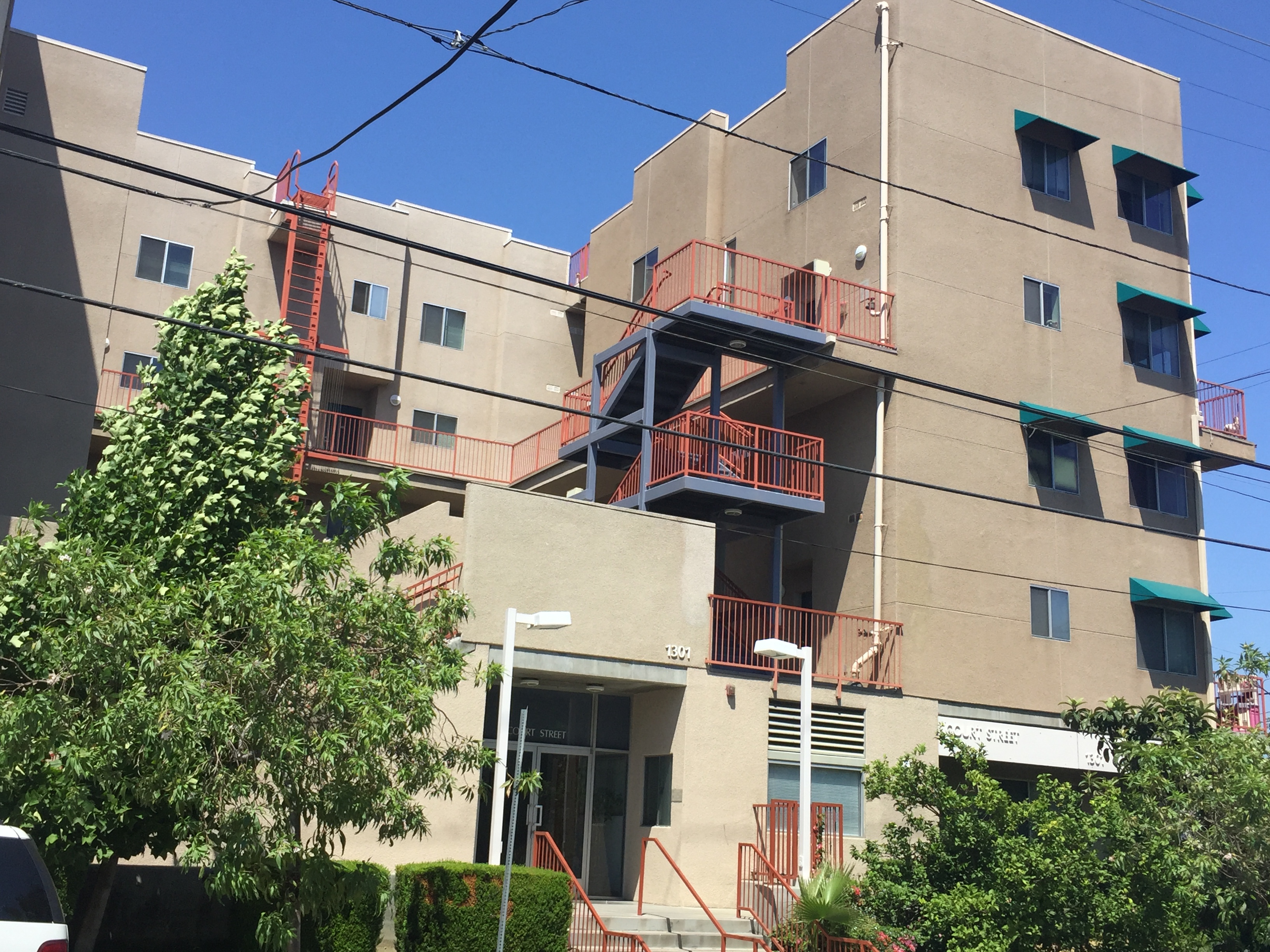 Street view of a three story building in biege color