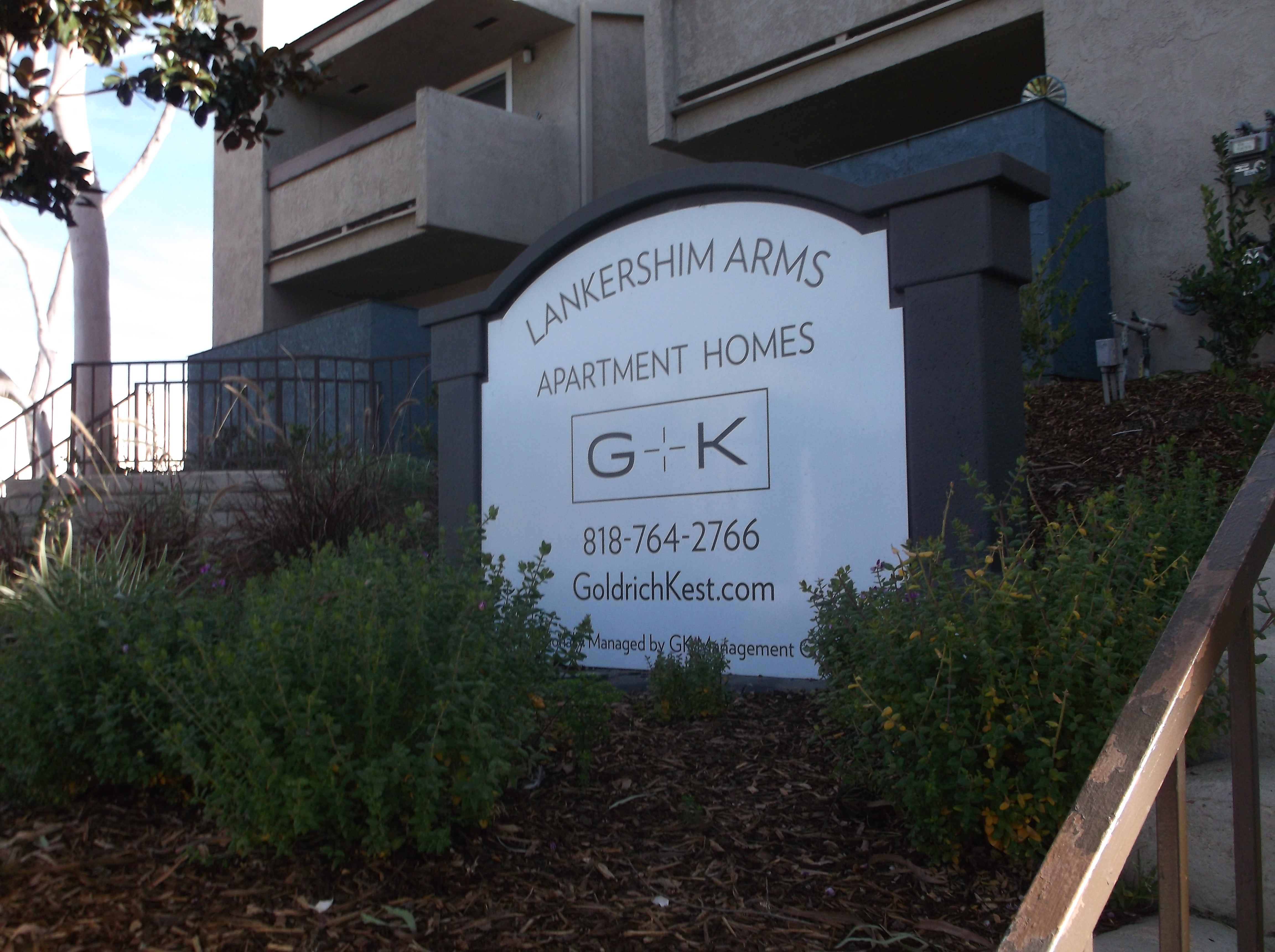 The front of Lankershim Arms Apartments showing the Goldrich Kest Management logo and phone number 818-764-2766