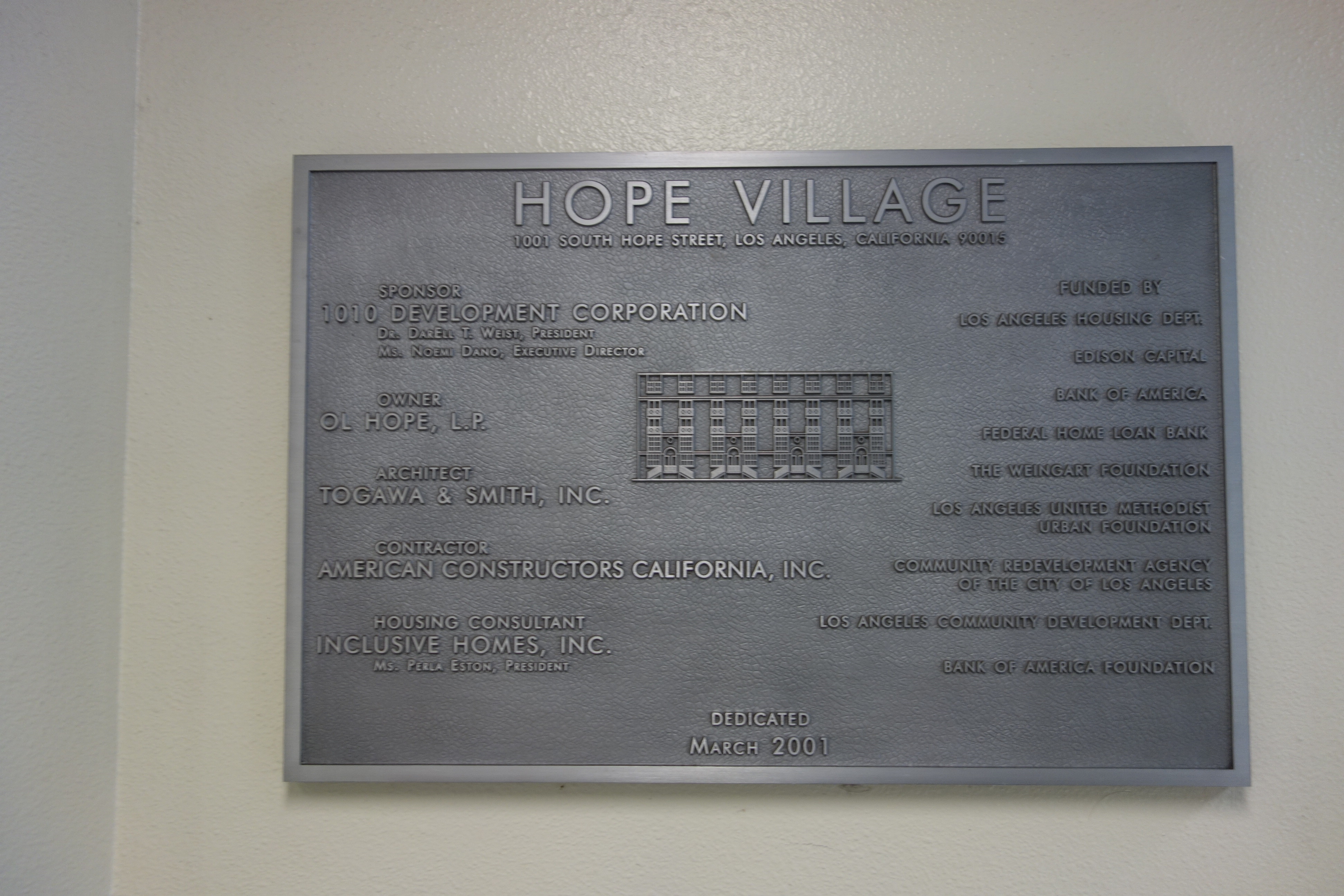 A close up image of a plaque with the information for Hope Village