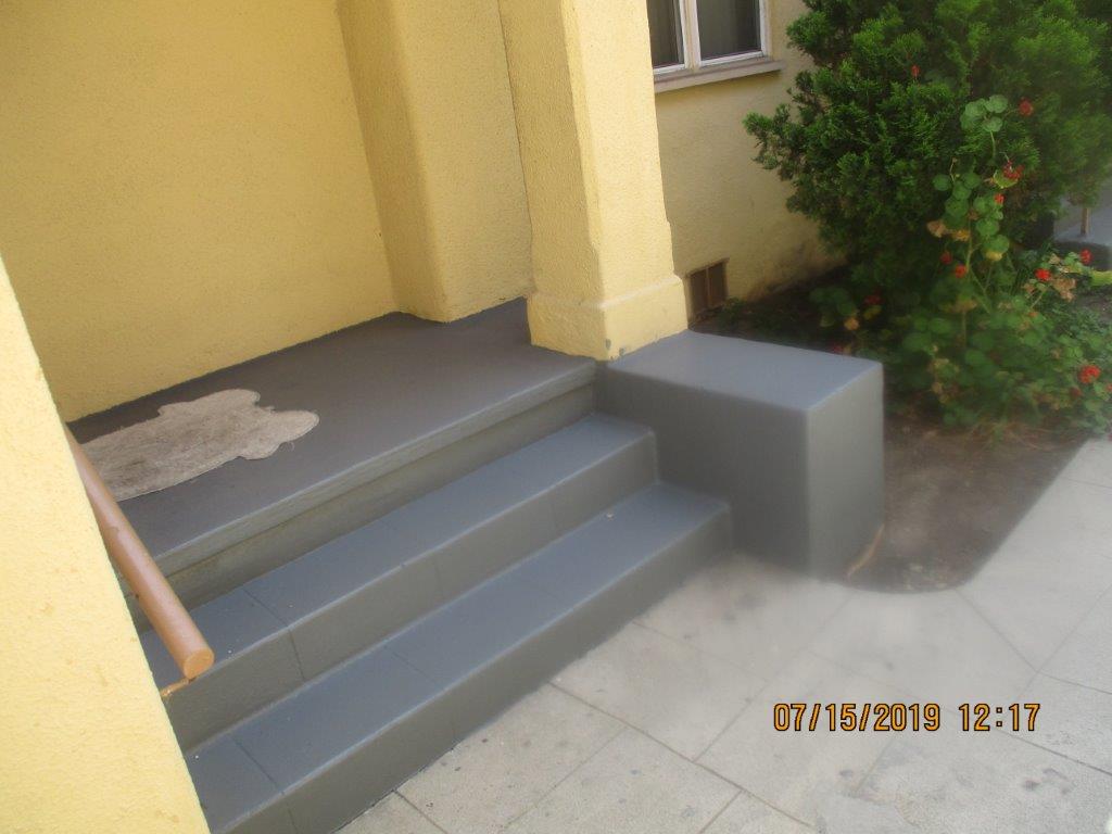 Close up image of steps lead to up to a landing to the building