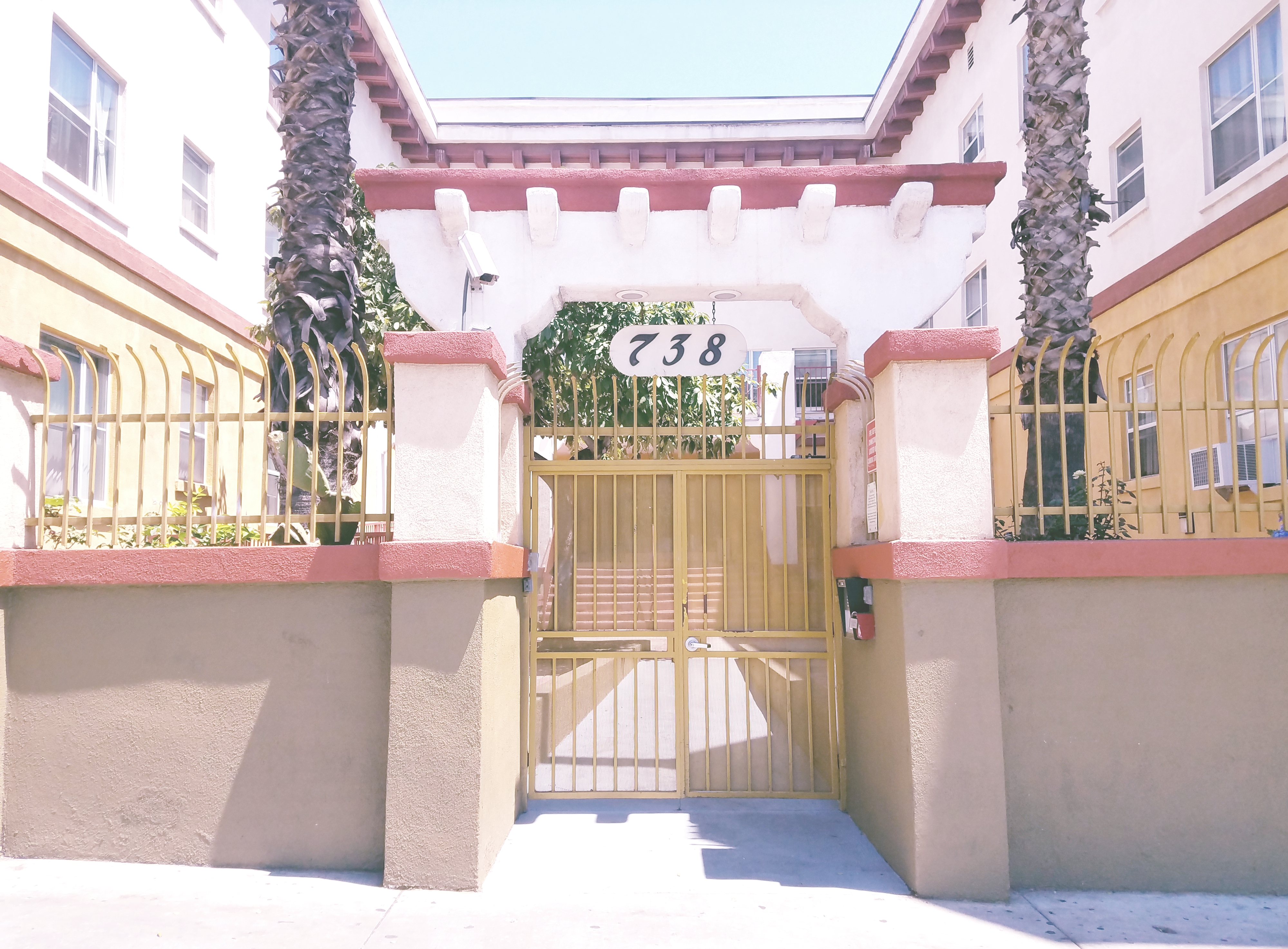 Image of the front entrance of the building with 738 written above the gate
