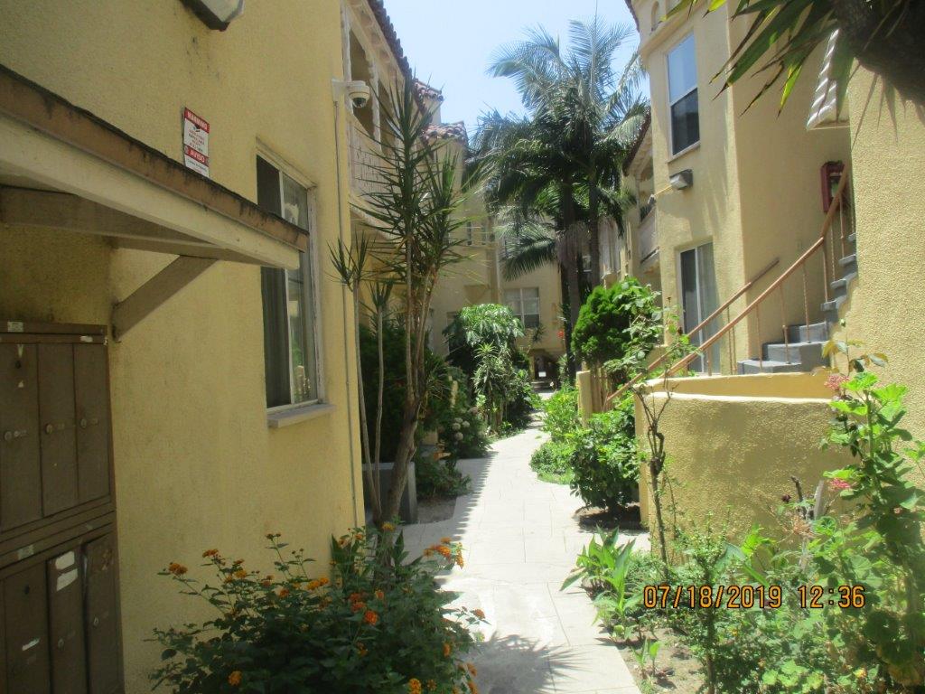 Image of walkway in between the units of the property with landscaping