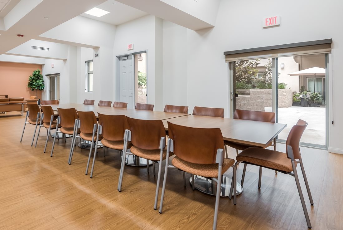 Inside view of the building community room with a long dining table