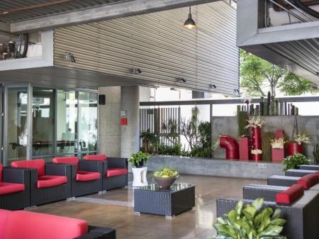Interior view of the Metropolitan Lofts, large common area with red and black lounge chairs